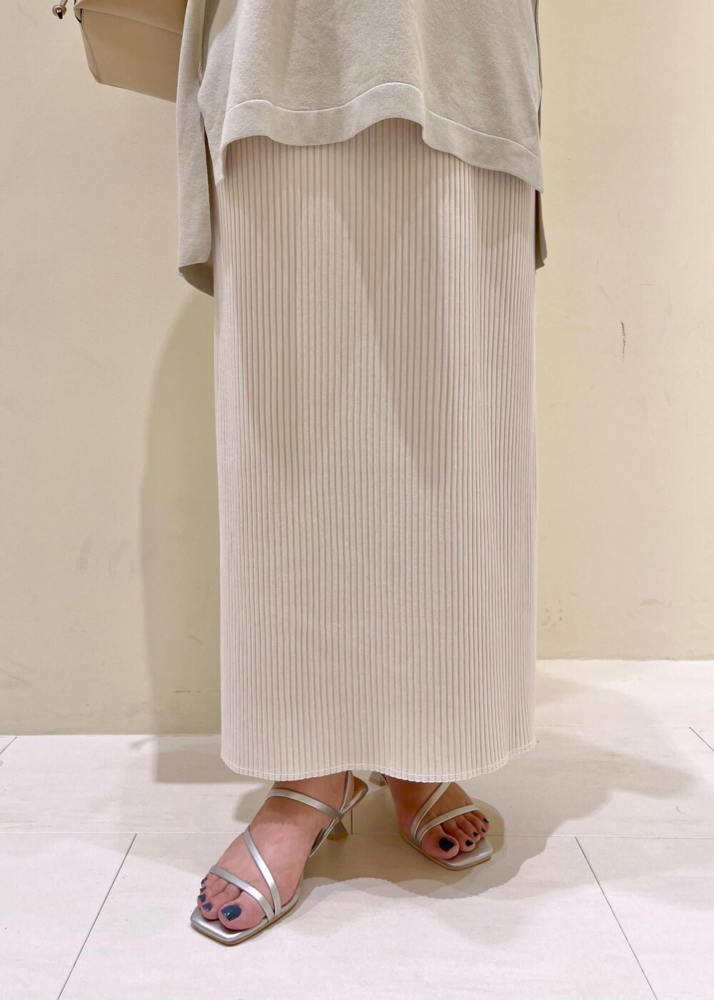 ベージュ系のタンクトップ、シルバー系のサンダル、ベージュ系のショルダーバッグを着用したレディースの夏コーディネートの8枚目の写真