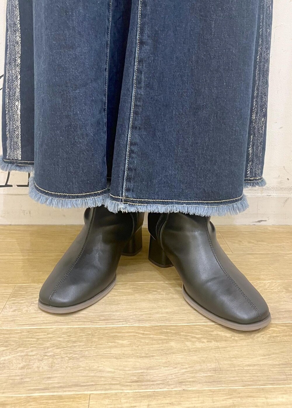 ブラック系のブーツ、グレー系のショルダーバッグ、ブルー系のデニムスカートを着用したレディースの冬コーディネートの10枚目の写真