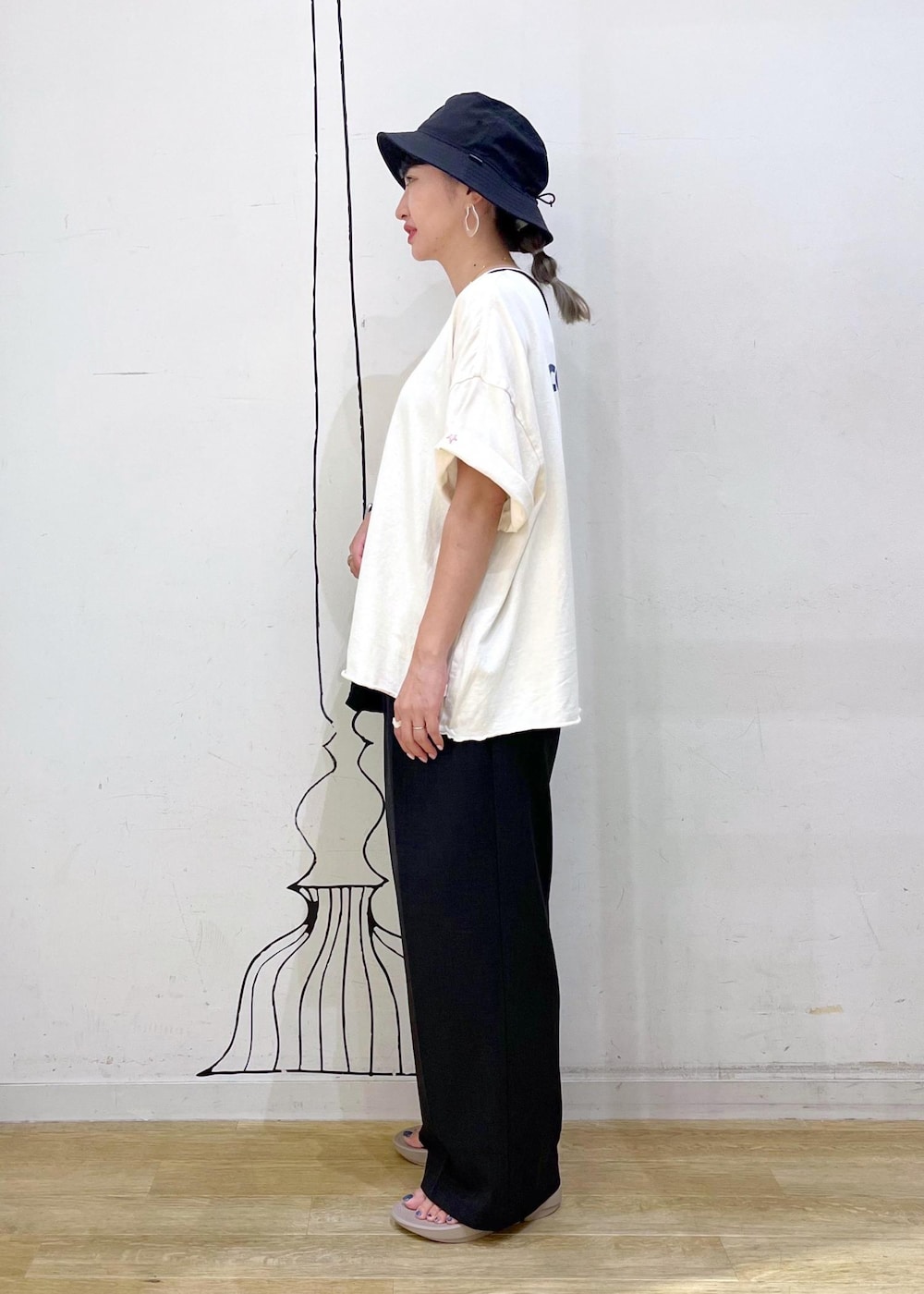 グレー系のその他パンツ、ホワイト系のTシャツ/カットソー、ブラック系のショルダーバッグを着用したレディースの夏コーディネートの4枚目の写真