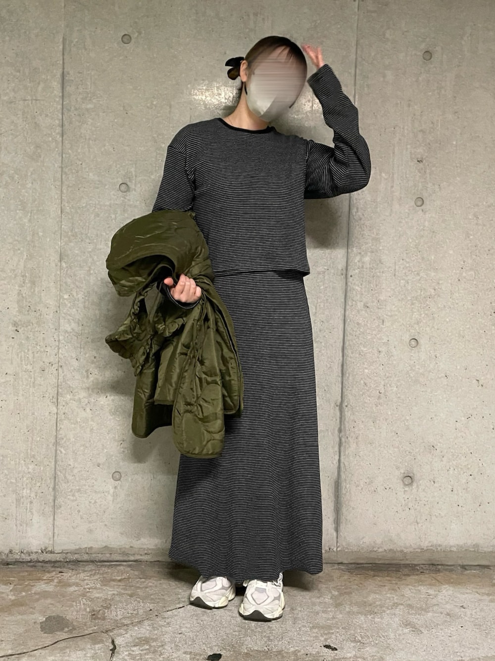 グリーン系のその他アウター、ブラック系のワンピース、ピンク系のスニーカーを着用したレディースの冬コーディネートの2枚目の写真