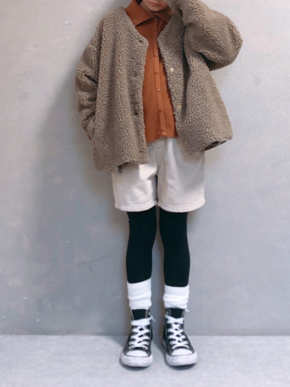 ホワイト系のデニムパンツ、イエロー系のニット/セーター、ベージュ系のノーカラージャケットを着用したキッズの冬コーディネートの3枚目の写真