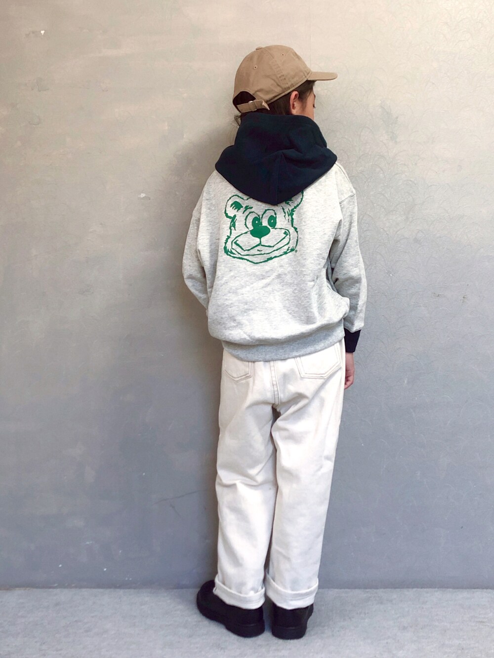 ホワイト系のパーカー、ベージュ系のデニムパンツ、ブラック系のその他シューズを着用したキッズの秋コーディネートの2枚目の写真