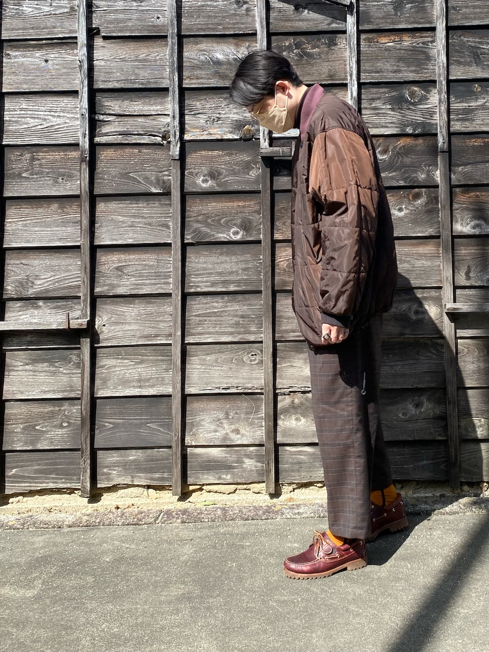 ブラウン系のジャケット/アウター、ブラウン系のTシャツ/カットソー、ブラウン系のスラックスを着用したメンズの春コーディネートの2枚目の写真