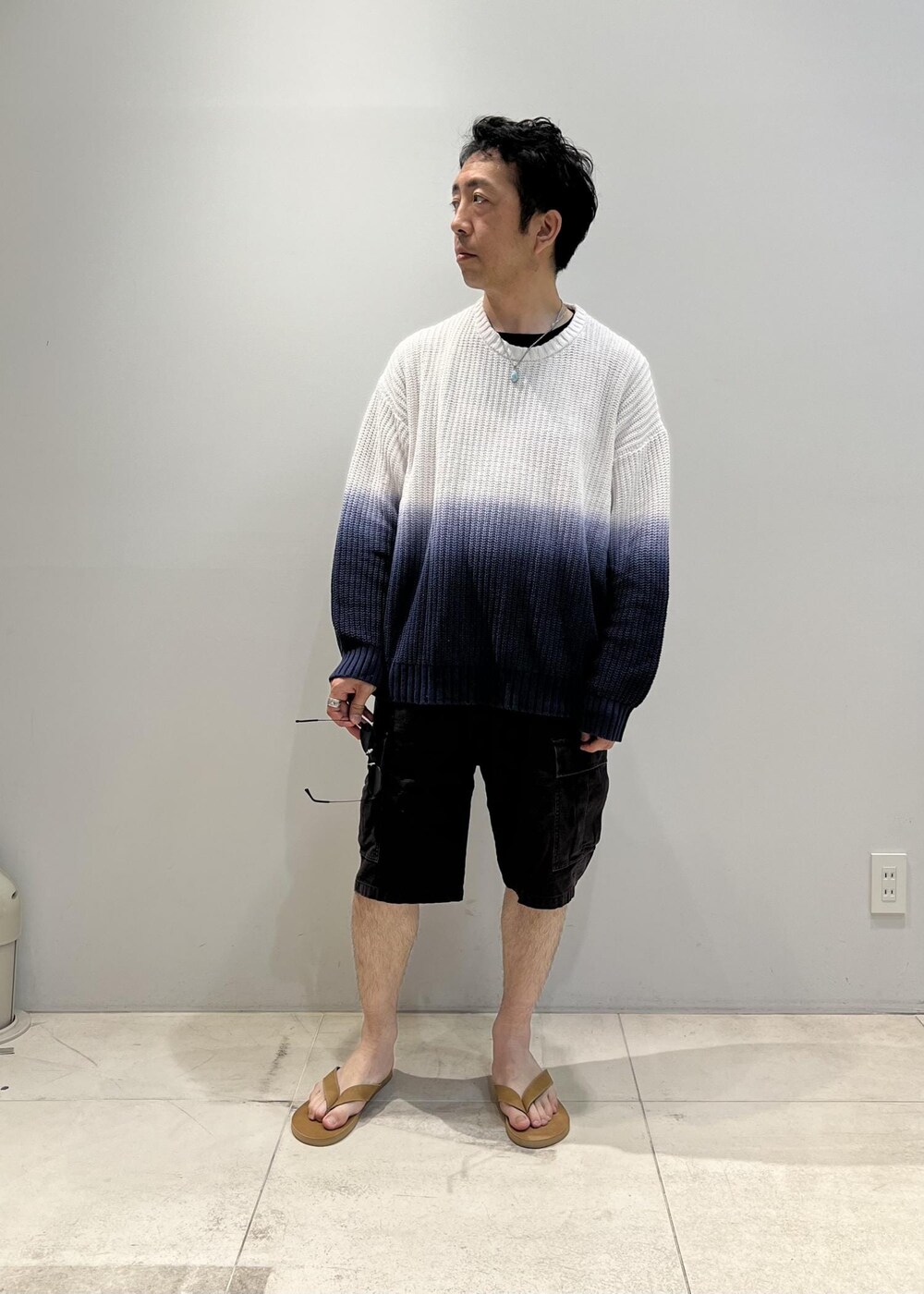 オレンジ系のニット/セーターを着用したメンズの夏コーディネートの5枚目の写真
