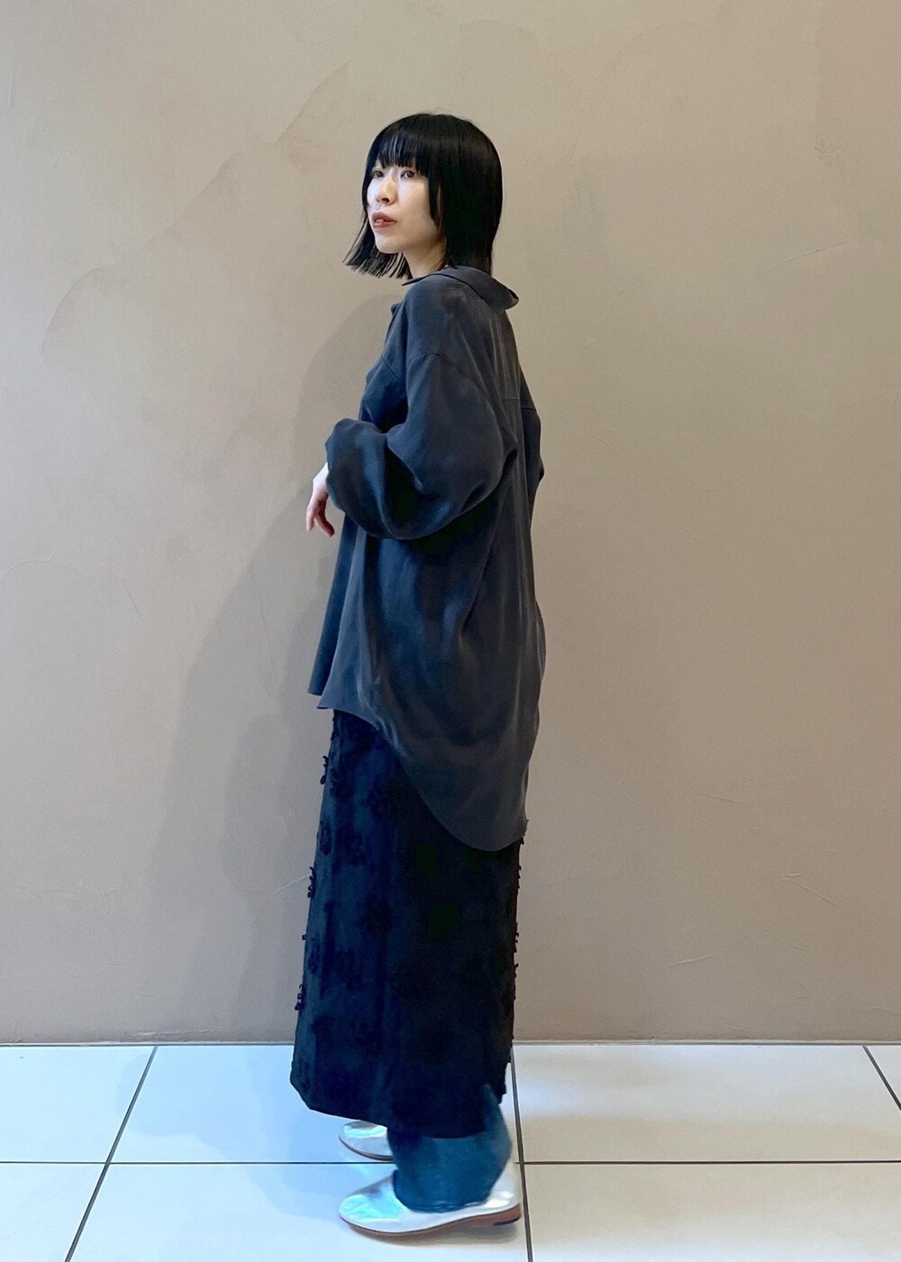 グレー系のシャツ/ブラウス、ブラック系のショルダーバッグ、ブルー系のデニムパンツを着用したレディースの春コーディネートの3枚目の写真