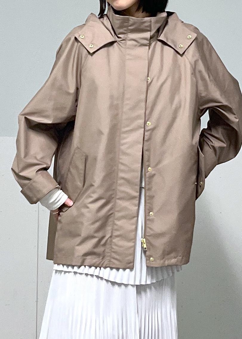 ブラウン系のマウンテンパーカー、グレー系のスカート、ブルー系のデニムパンツを着用したレディースの冬コーディネートの5枚目の写真