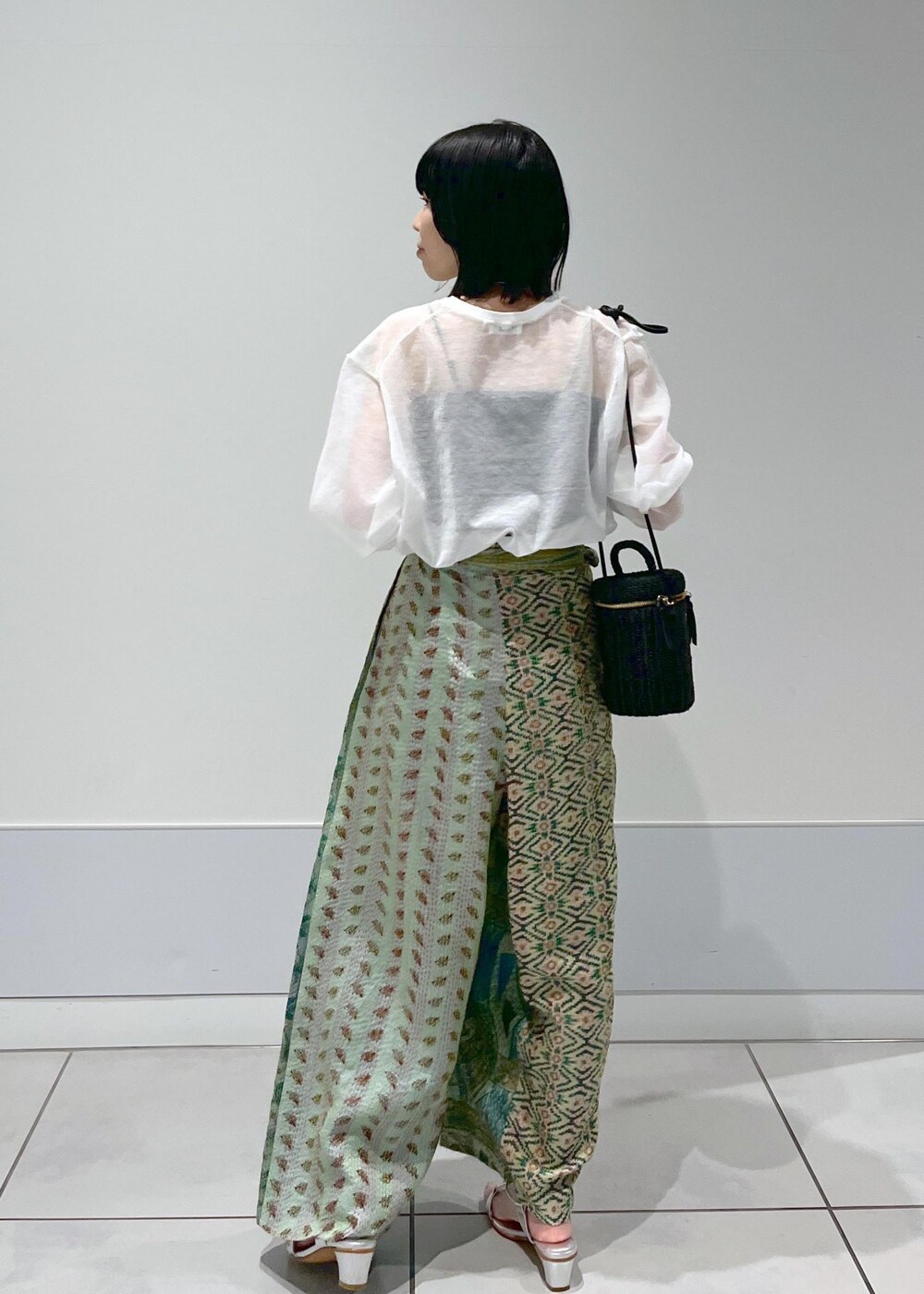 ホワイト系のTシャツ/カットソー、ブラック系のショルダーバッグ、シルバー系のサンダルを着用したレディースの春コーディネートの2枚目の写真