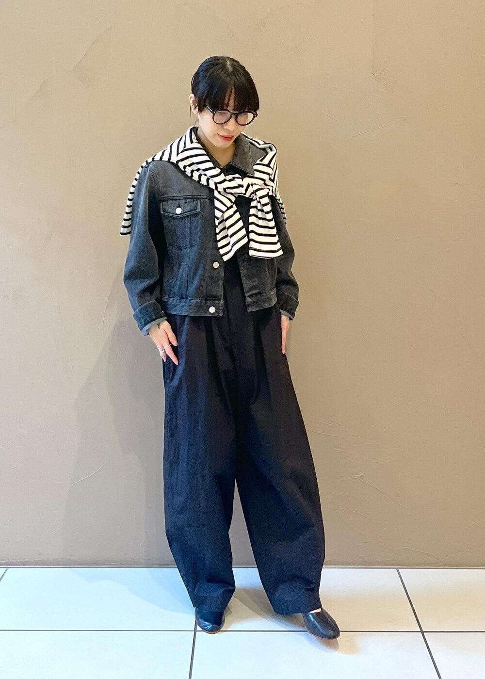 ブラック系のタンクトップ、グレー系のデニムジャケット、ブラック系のその他パンツを着用したレディースの秋コーディネートの2枚目の写真