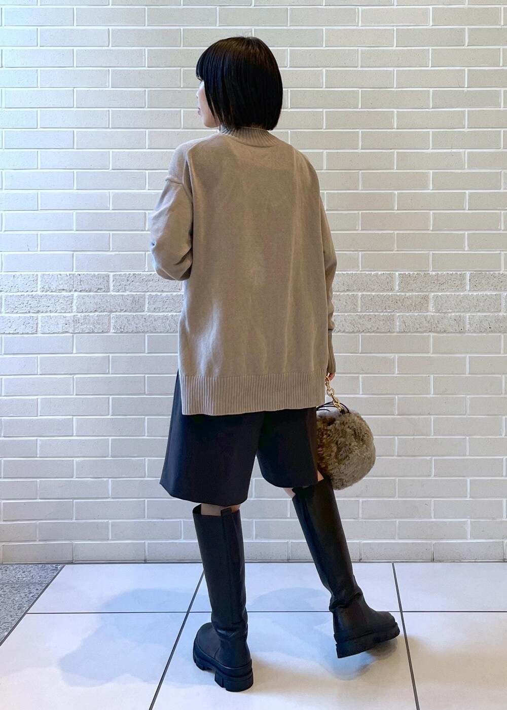 ブラック系のブーツ、グレー系のニット/セーター、グレー系のその他パンツを着用したレディースの秋コーディネートの2枚目の写真