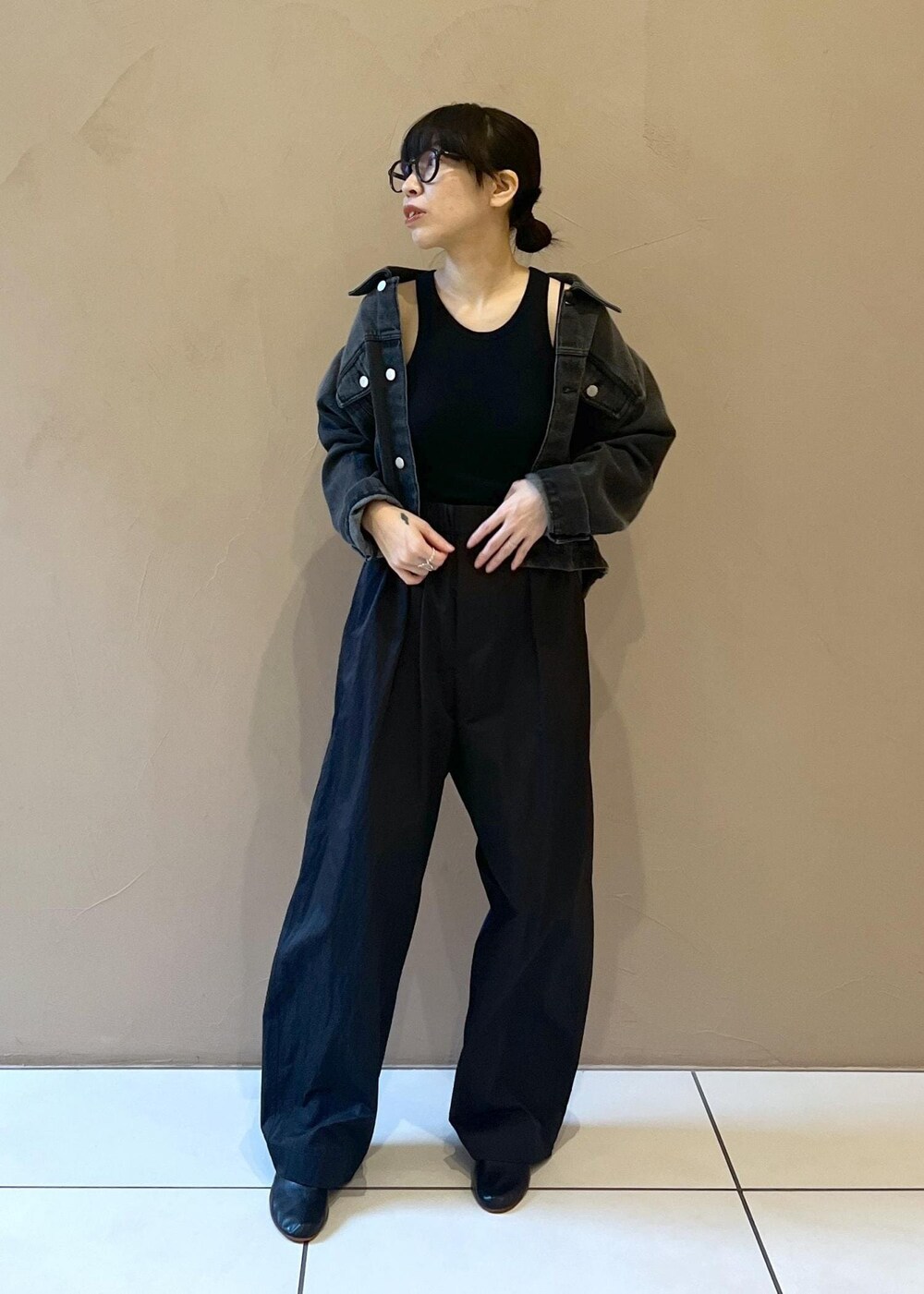 ブラック系のタンクトップ、グレー系のデニムジャケット、ブラック系のその他パンツを着用したレディースの秋コーディネートの5枚目の写真