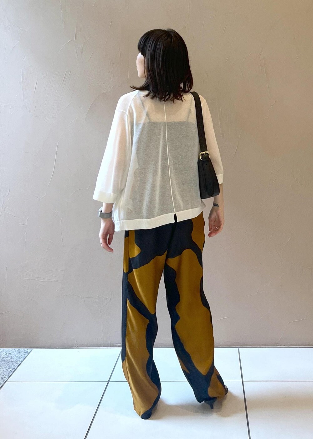 ホワイト系のカーディガン/ボレロ、ブラック系のショルダーバッグを着用したレディースの夏コーディネートの3枚目の写真