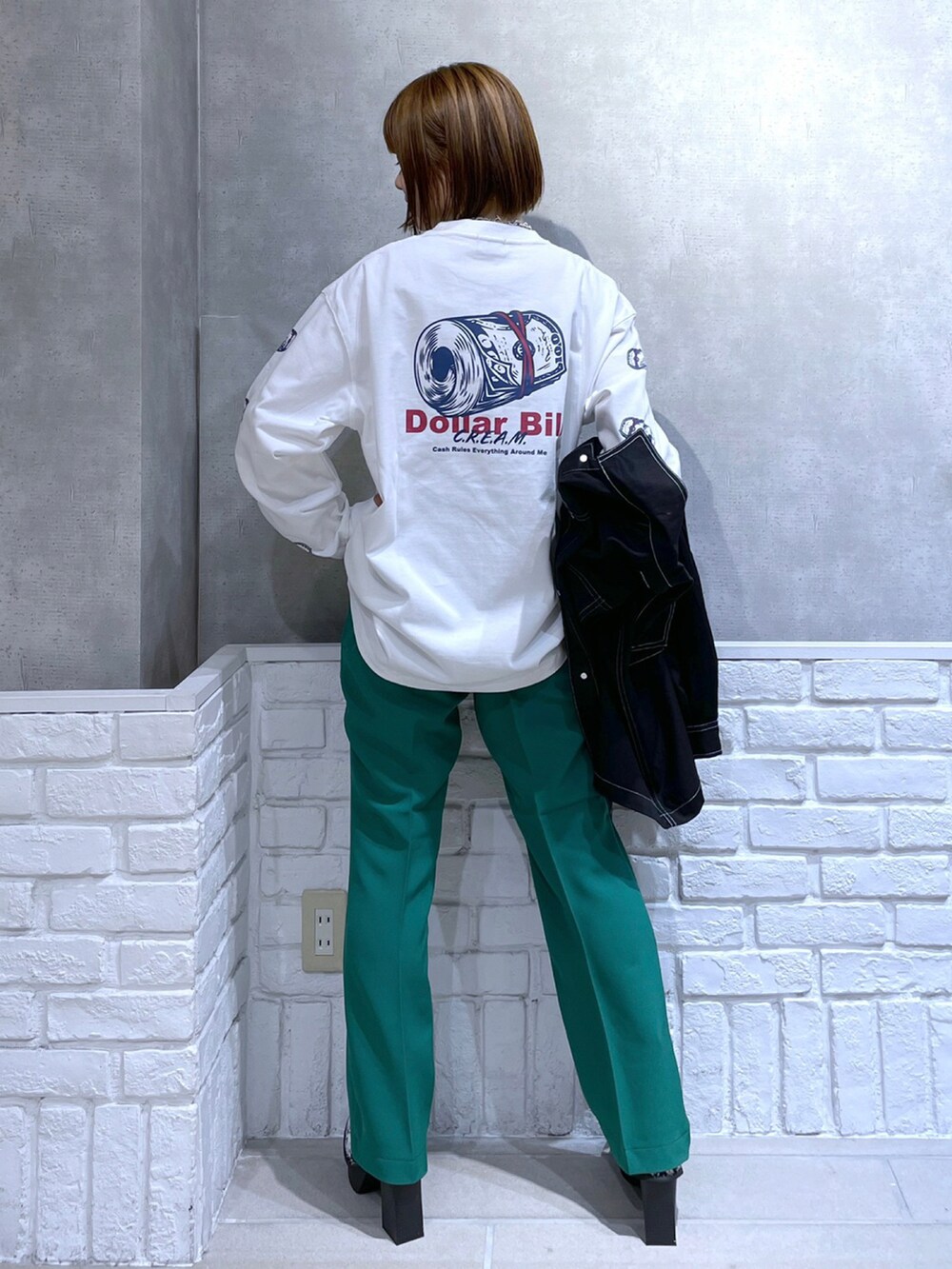 ホワイト系のTシャツ/カットソー、ブラック系のカバーオール、グリーン系のパンツを着用したレディースの冬コーディネートの3枚目の写真