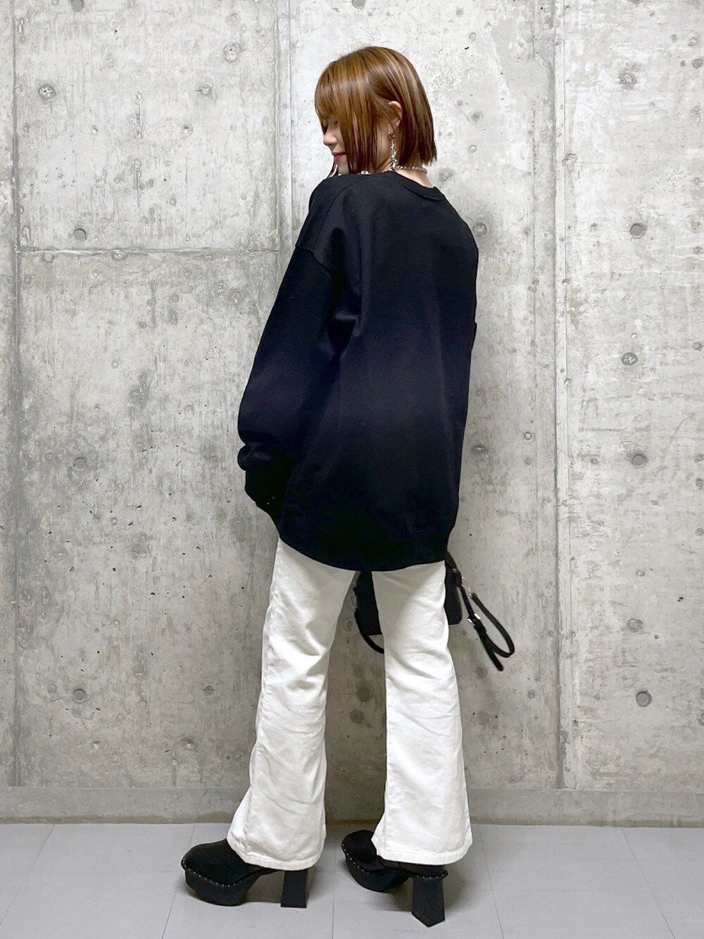 ブラック系のスウェット、ブルー系のニット/セーター、ブラック系のボストンバッグを着用したレディースの冬コーディネートの4枚目の写真