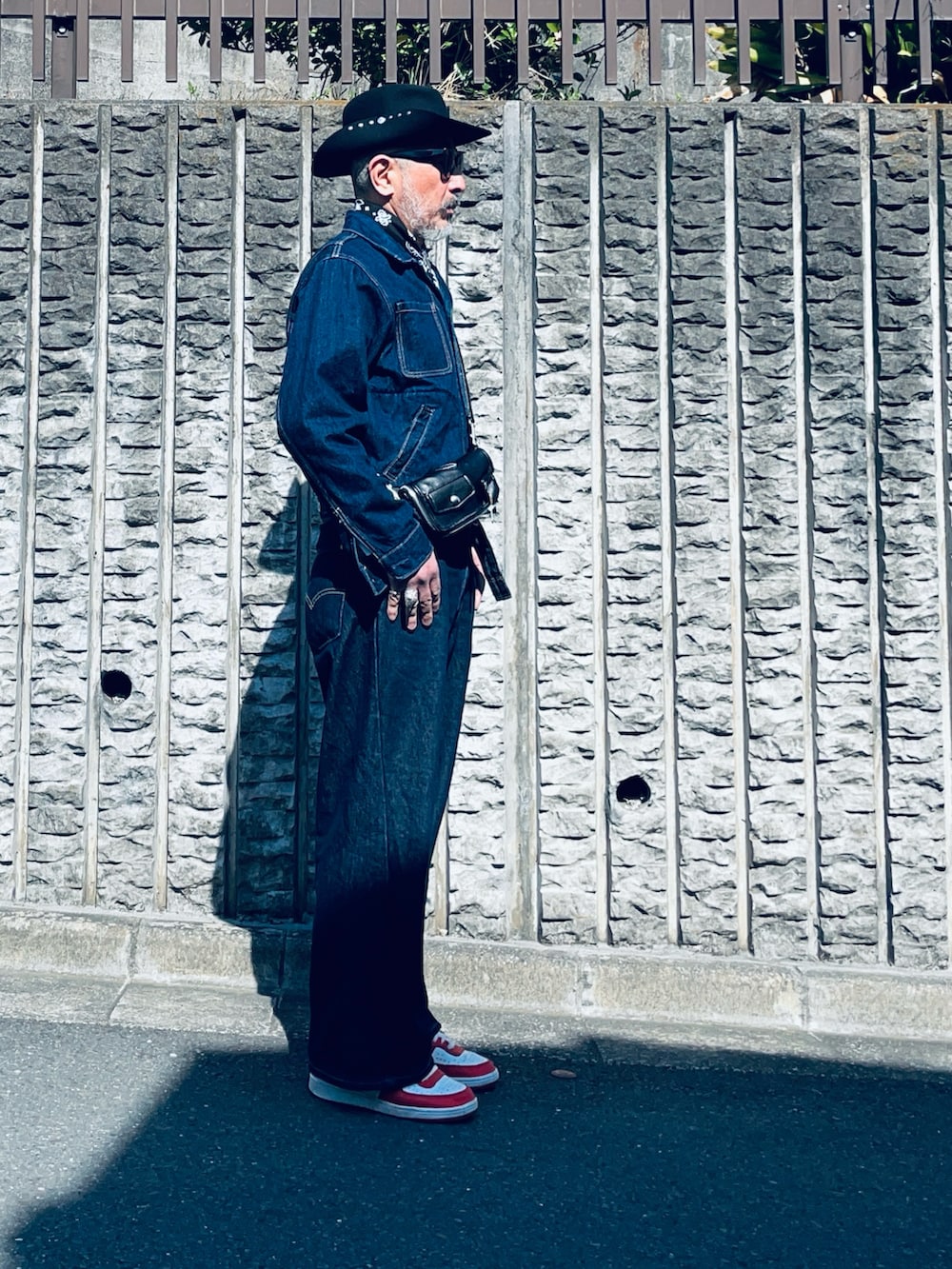 ブルー系のデニムパンツ、ブラック系のボディバッグ/ウエストポーチ、ブルー系のデニムジャケットを着用したメンズの春コーディネートの2枚目の写真