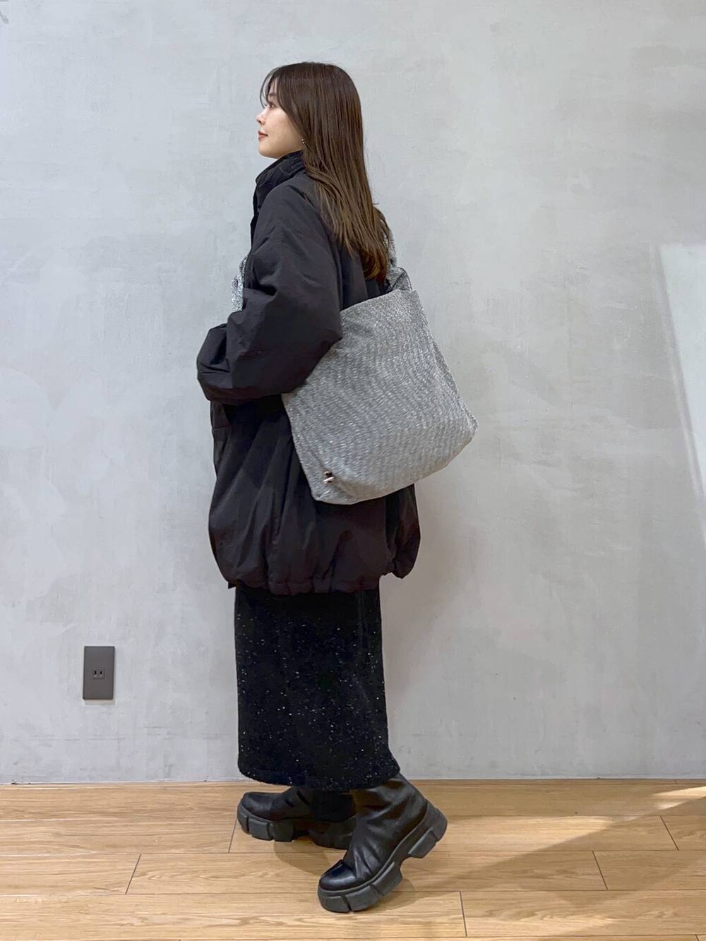 ブラック系のダウンジャケット/コート、シルバー系のショルダーバッグ、ブラック系のブーツを着用したレディースの秋コーディネートの4枚目の写真