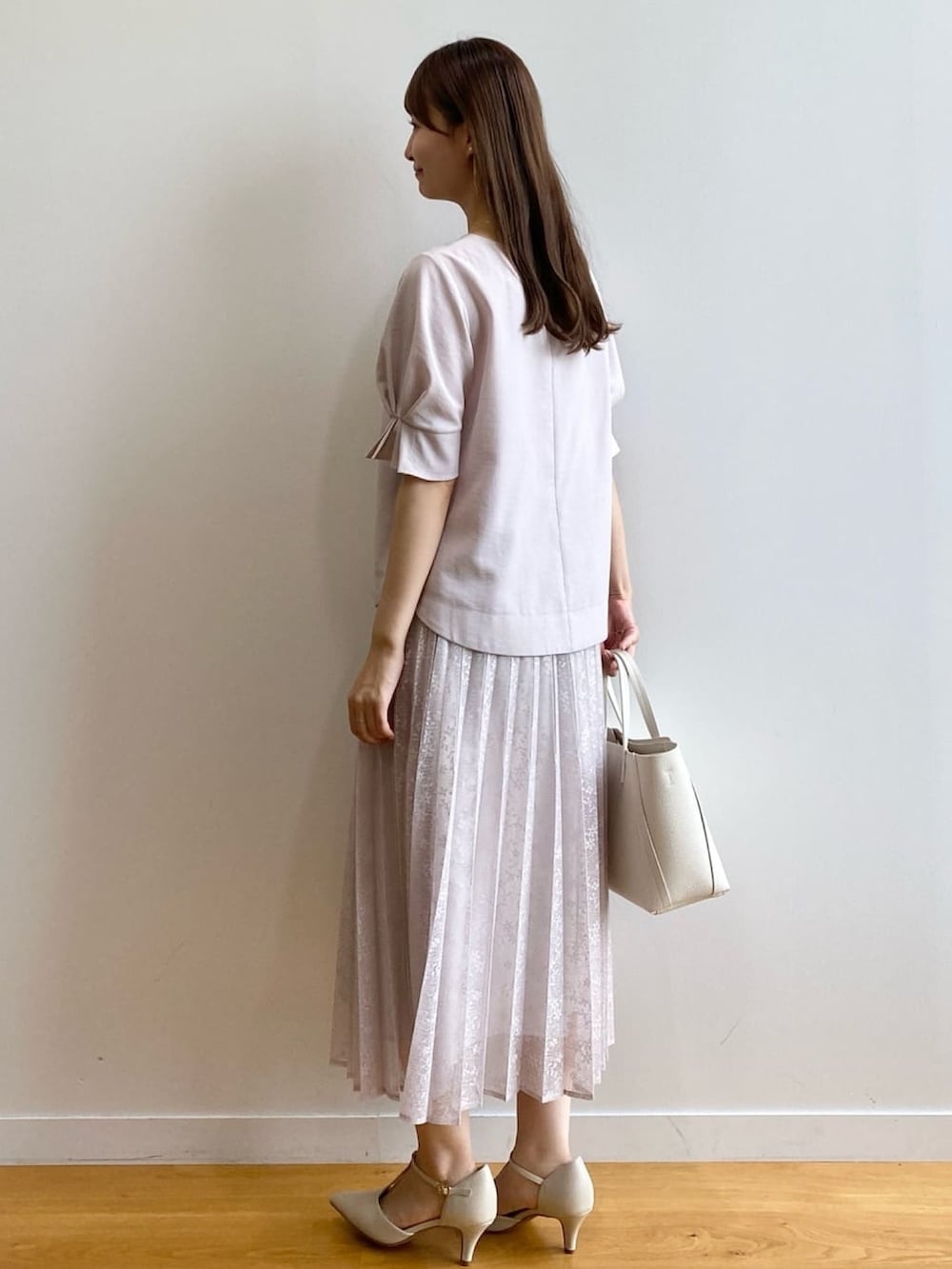 ベージュ系のシャツ/ブラウス、ベージュ系のスカート、ホワイト系のトートバッグを着用したレディースの夏コーディネートの5枚目の写真