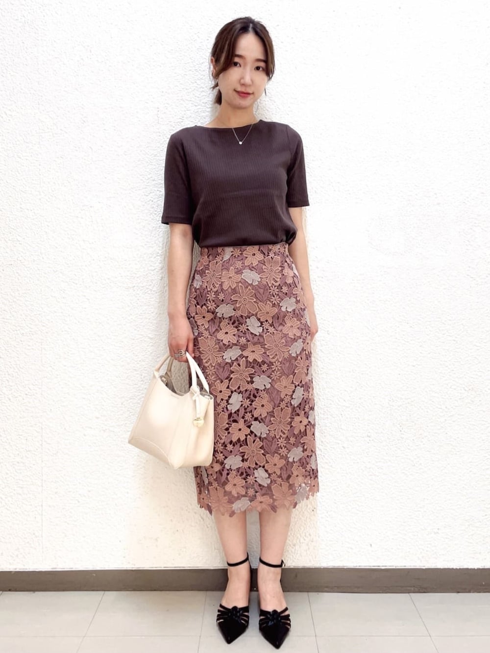 ブラウン系のTシャツ/カットソー、ピンク系のスカート、ホワイト系のトートバッグを着用したレディースの夏コーディネートの2枚目の写真