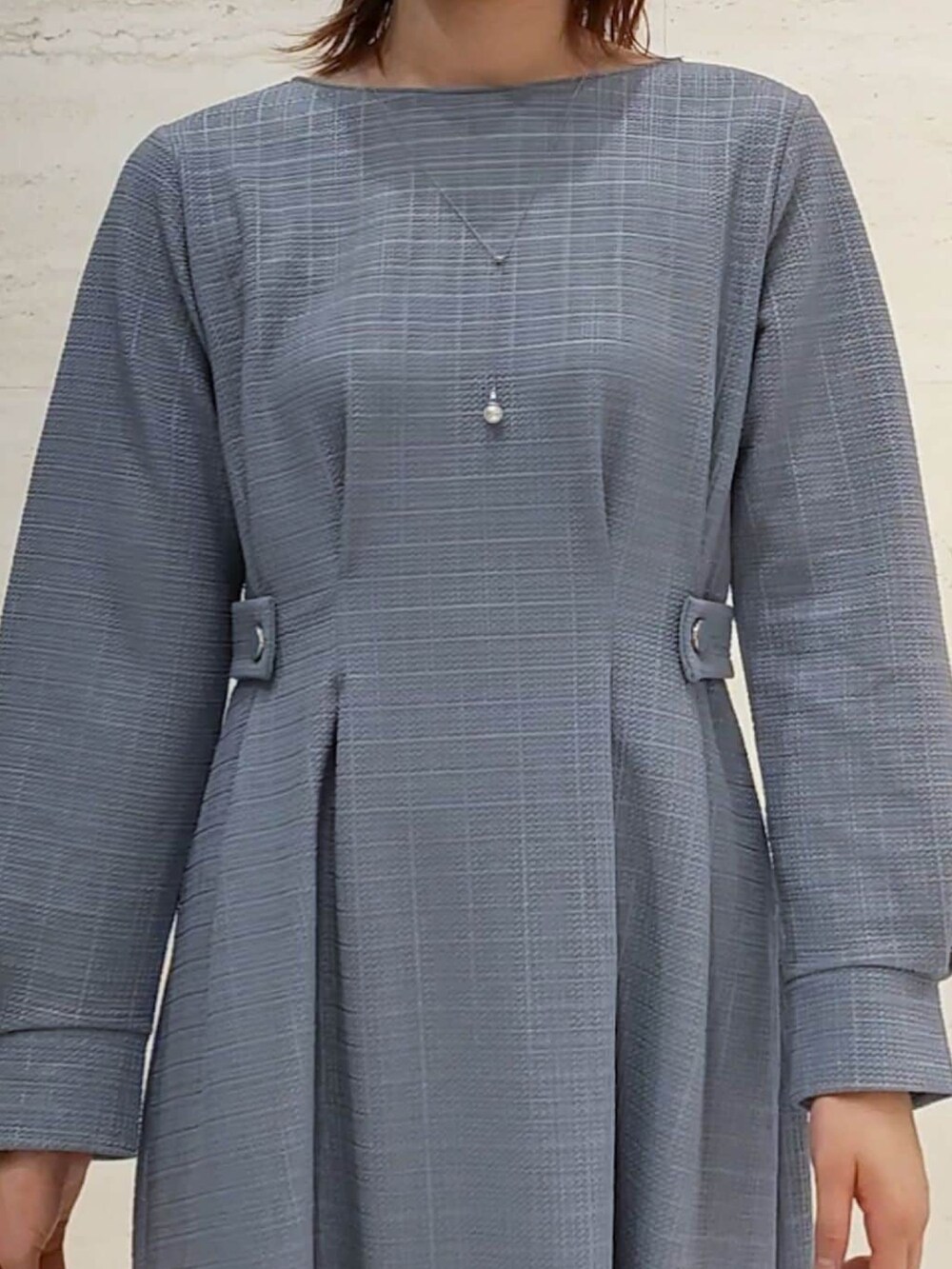 ブルー系のワンピース、シルバー系のショルダーバッグ、ブラック系のブーツを着用したレディースの秋コーディネートの4枚目の写真