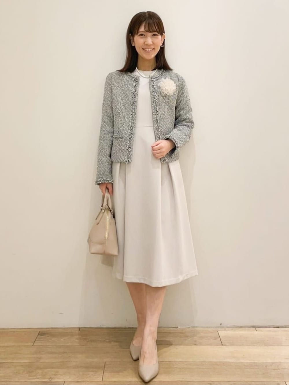 ベージュ系のワンピース、ベージュ系のショルダーバッグ、ベージュ系のパンプスを着用したレディースの春コーディネートの2枚目の写真