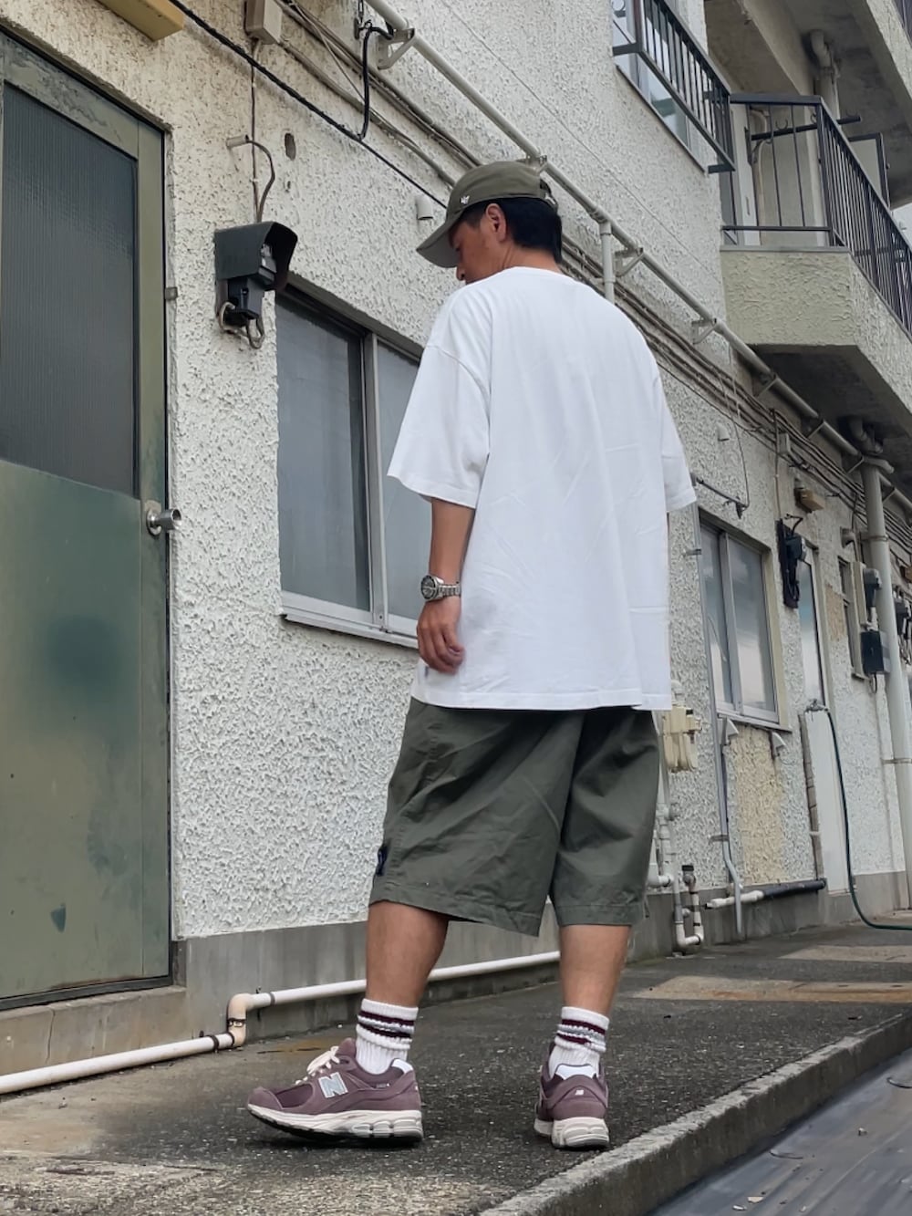 ブラウン系のスニーカー、グリーン系のその他パンツ、ホワイト系のTシャツ/カットソーを着用したメンズの秋コーディネートの2枚目の写真