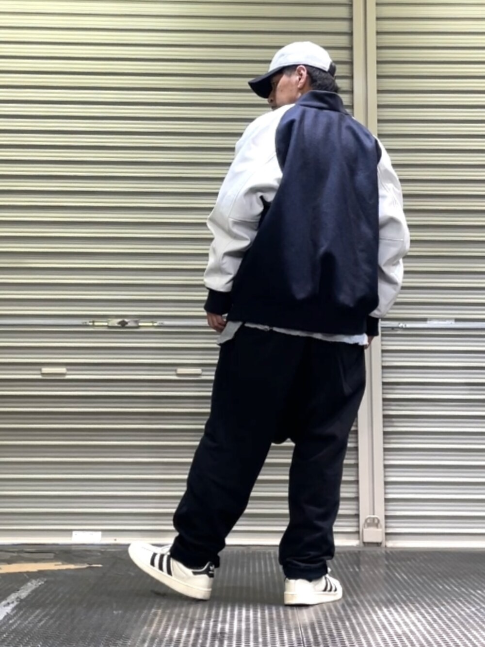 ホワイト系のスニーカー、ブラック系のその他パンツ、グレー系のTシャツ/カットソーを着用したメンズの秋コーディネートの2枚目の写真