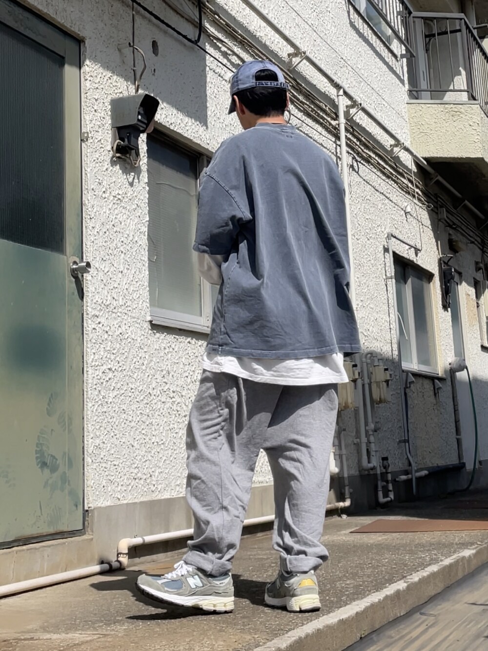 グレー系のスニーカー、グレー系のその他パンツ、ブルー系のTシャツ/カットソーを着用したメンズの春コーディネートの2枚目の写真