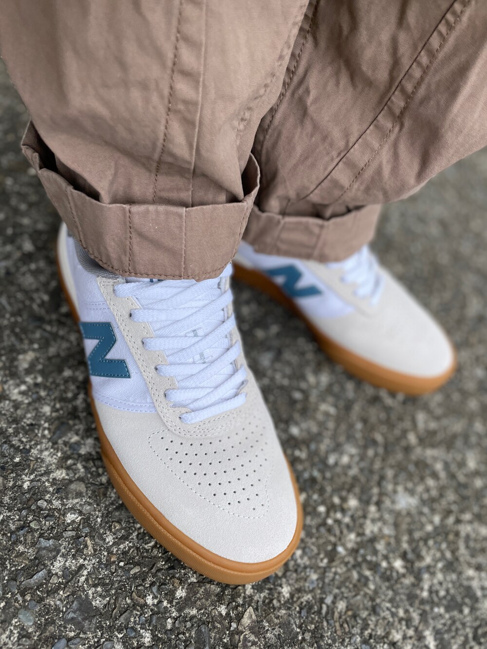 ベージュ系のパンツ、ブルー系のTシャツ/カットソー、ベージュ系のスニーカーを着用したメンズの秋コーディネートの3枚目の写真