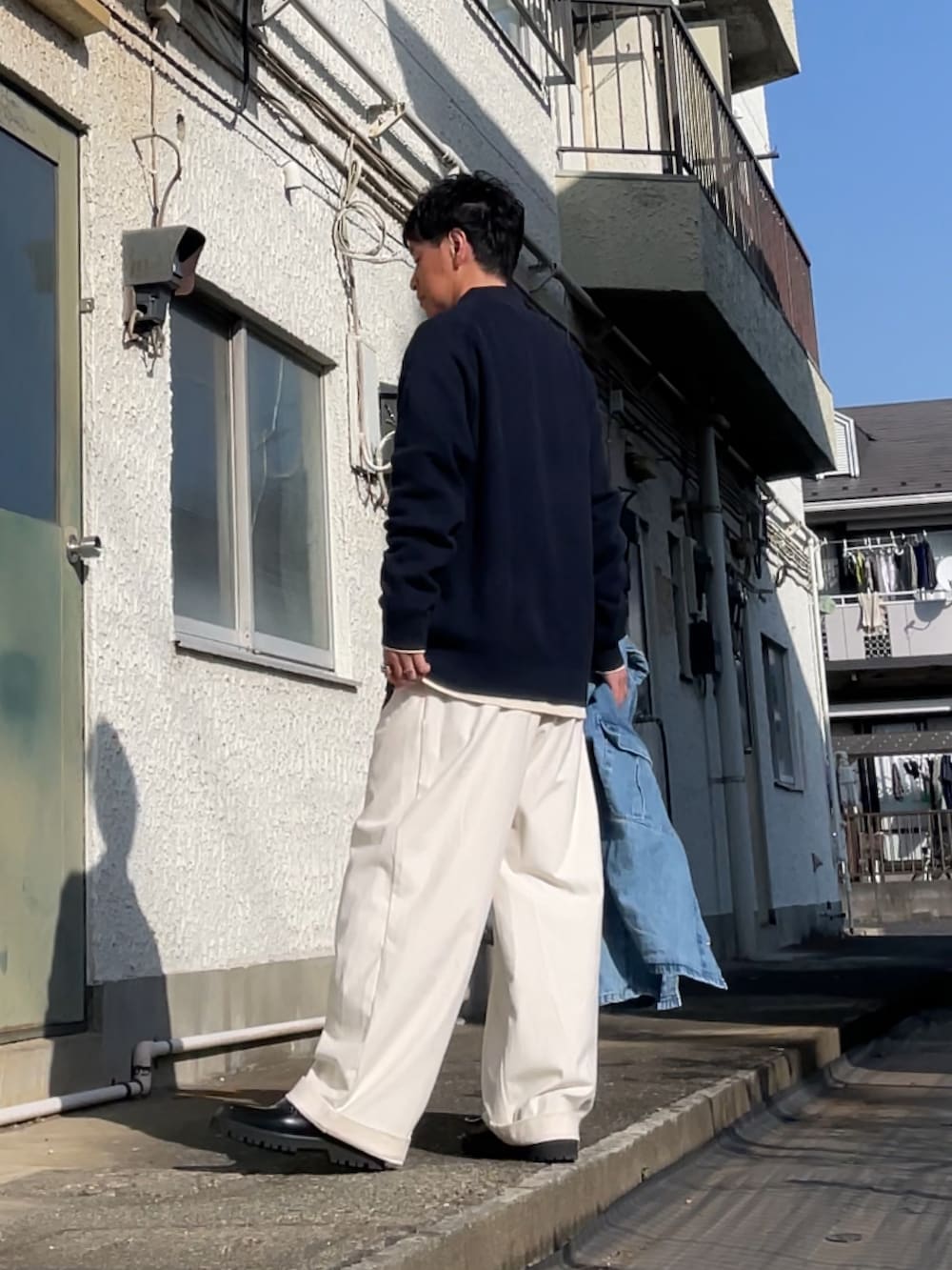 ホワイト系のその他パンツ、ブルー系のポロシャツ、ブラック系のローファーを着用したメンズの春コーディネートの2枚目の写真