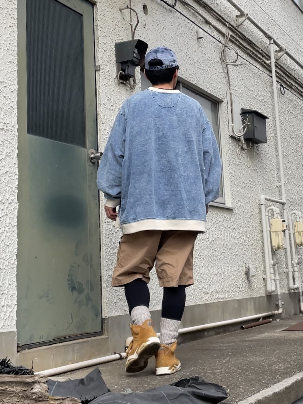 ブラウン系のスニーカー、ベージュ系のその他パンツ、ブルー系のトップスを着用したメンズの冬コーディネートの2枚目の写真