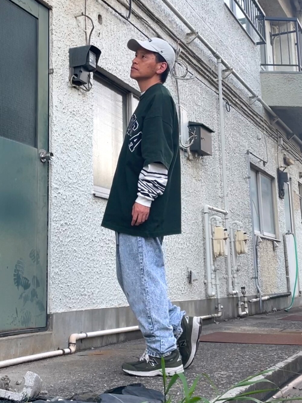 グリーン系のスニーカー、ブルー系のデニムパンツ、グリーン系のTシャツ/カットソーを着用したメンズの春コーディネートの2枚目の写真