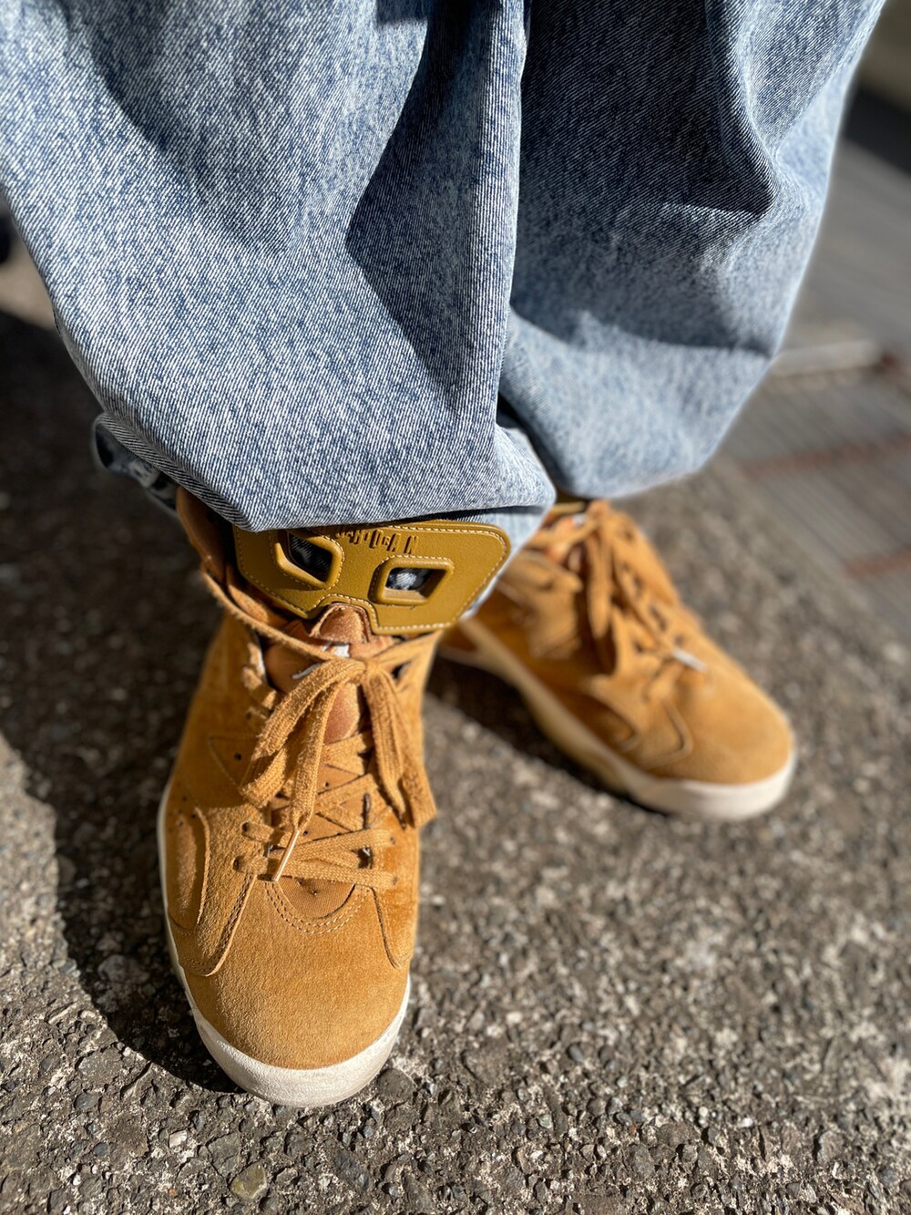 ブラウン系のスニーカー、ブルー系のデニムパンツ、イエロー系のニット/セーターを着用したメンズの春コーディネートの3枚目の写真