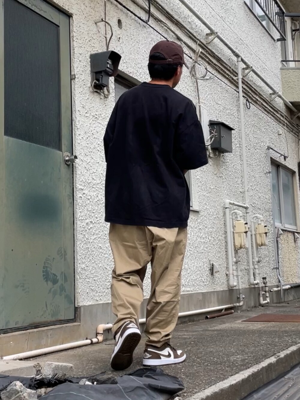 ブラウン系のスニーカー、ベージュ系のその他パンツ、ブラック系のTシャツ/カットソーを着用したメンズの秋コーディネートの2枚目の写真