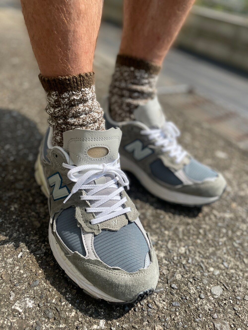 グレー系のスニーカー、グリーン系のカーゴパンツ、グレー系のTシャツ/カットソーを着用したメンズの夏コーディネートの3枚目の写真