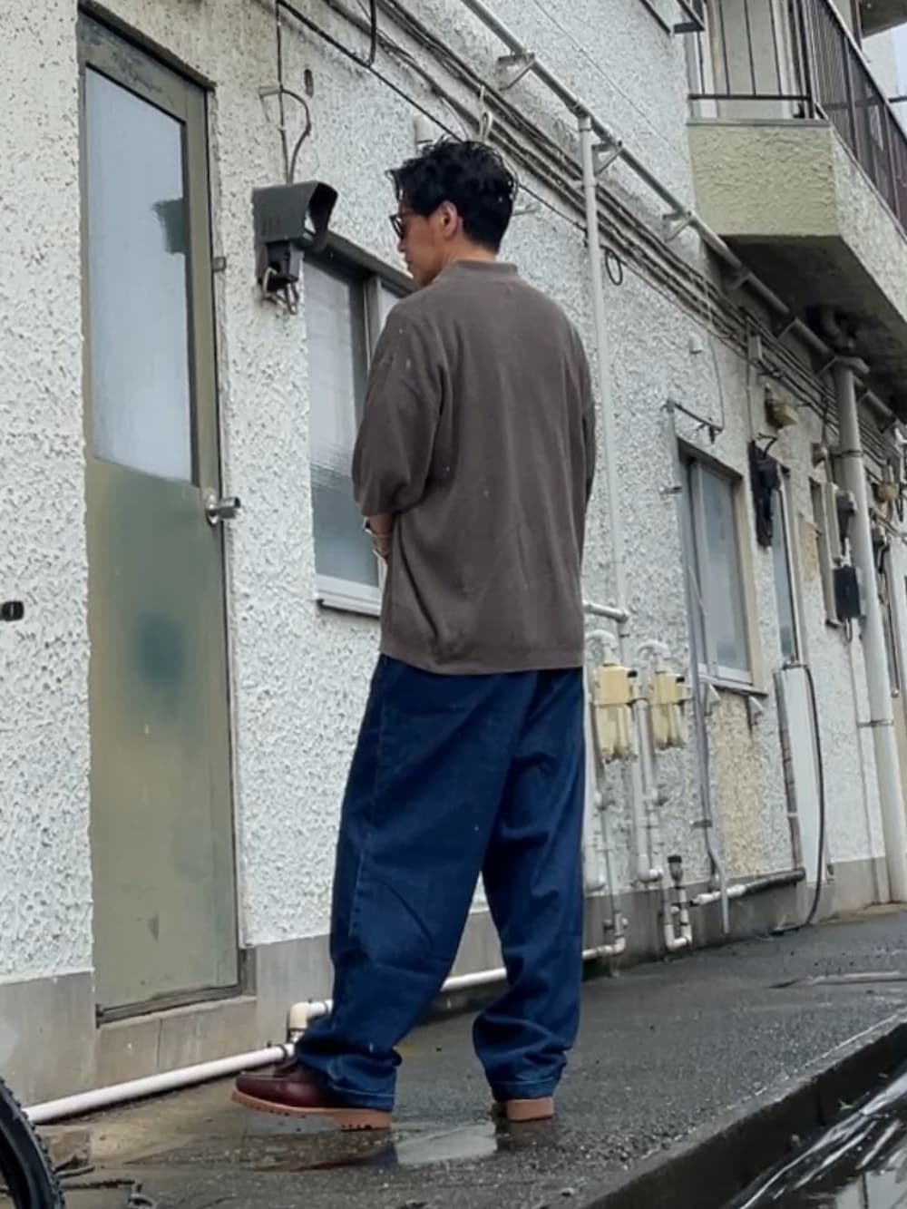 ブラウン系のポロシャツ、ブルー系のデニムパンツ、レッド系のローファーを着用したメンズの夏コーディネートの2枚目の写真