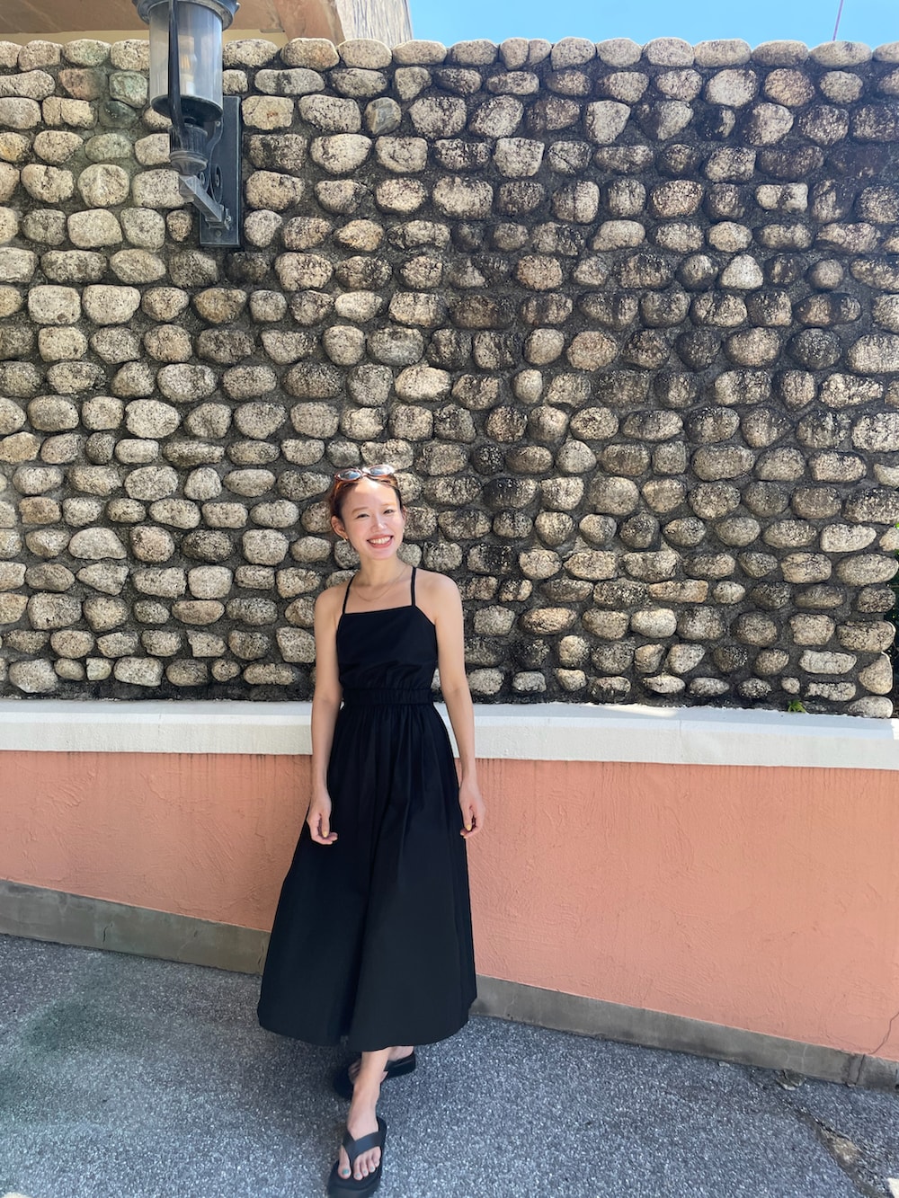 ブラック系のワンピースを着用したレディースの夏コーディネートの2枚目の写真