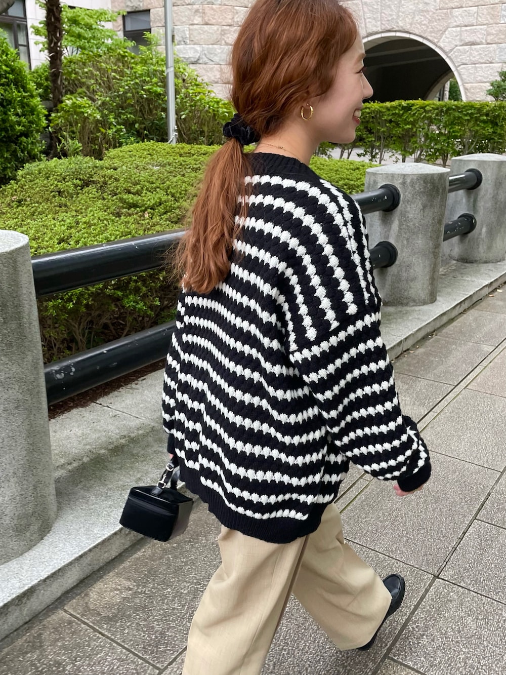 ブラック系のニット/セーター、ベージュ系のセットアップを着用したレディースの秋コーディネートの3枚目の写真