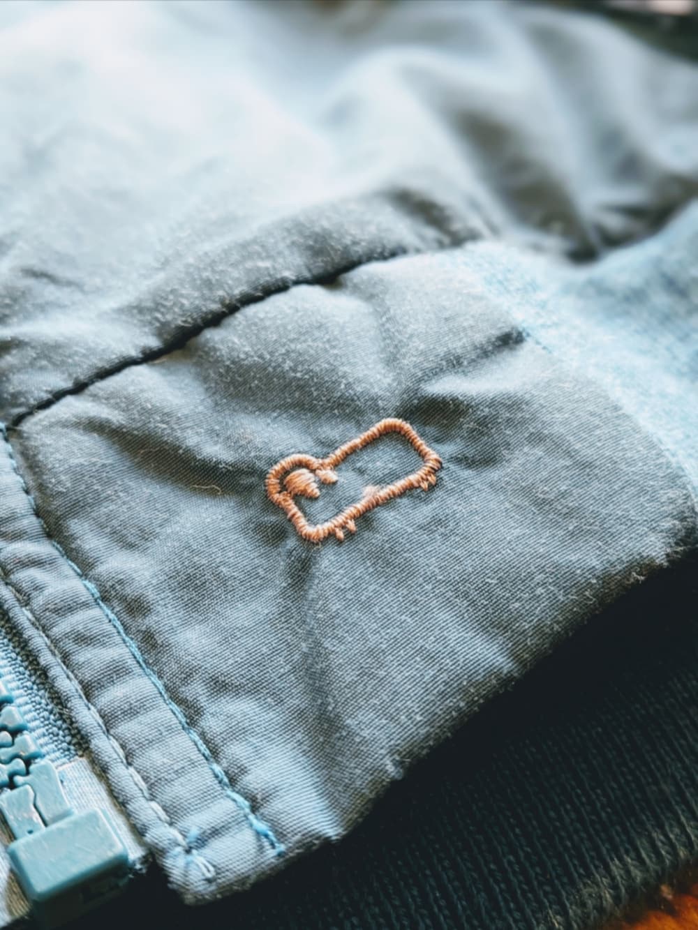 ブルー系のナイロンジャケットを着用したメンズの冬コーディネートの3枚目の写真