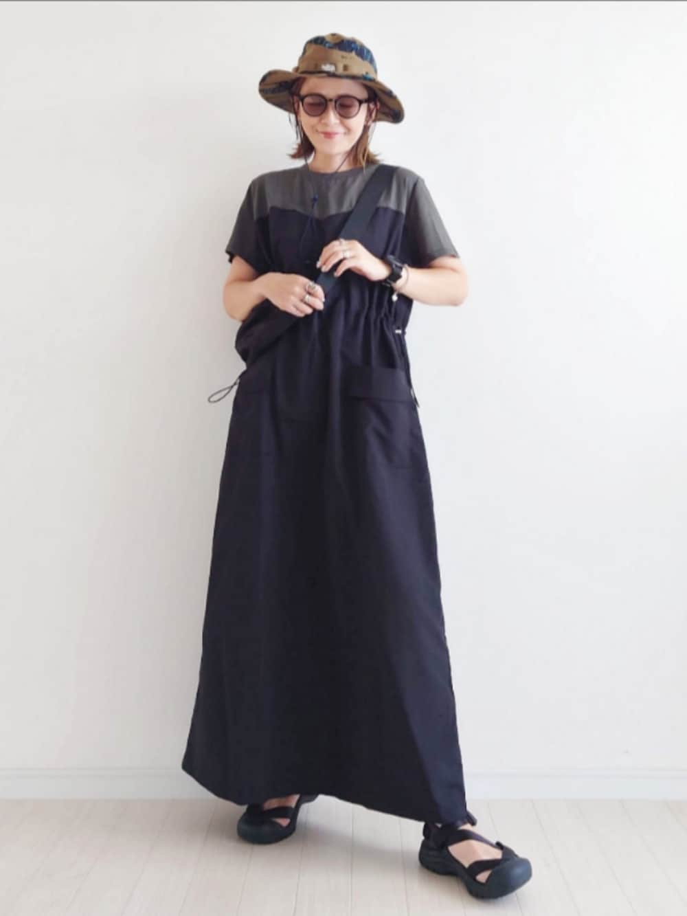 グレー系のワンピース、ブラック系のサンダル、ブラック系のボディバッグ/ウエストポーチを着用したレディースの夏コーディネートの4枚目の写真