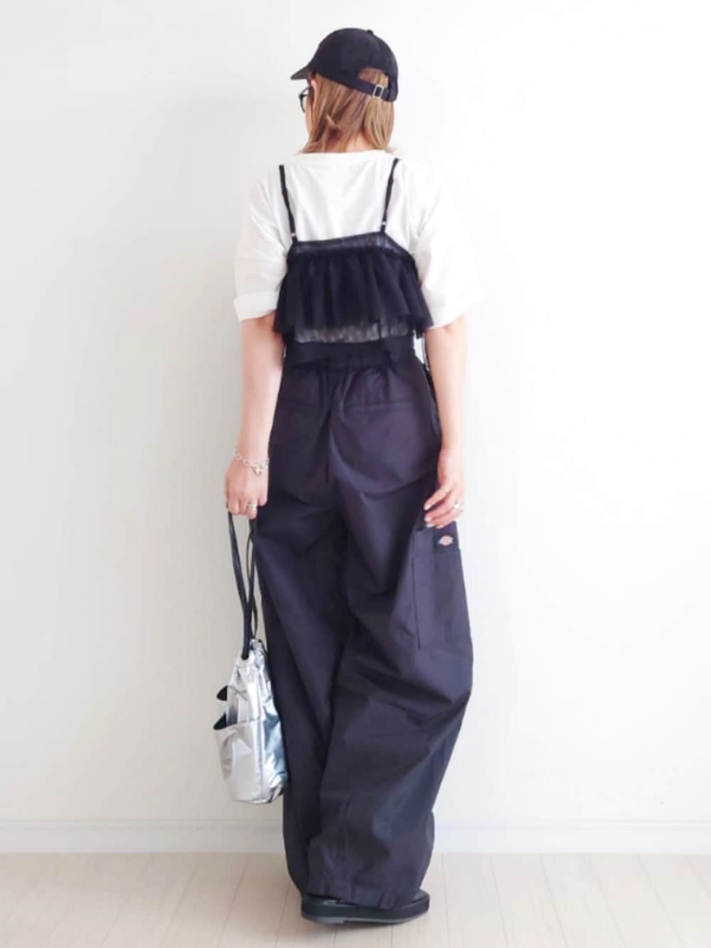 ブラック系のカーゴパンツ、ブラック系のキャミソール、ホワイト系のTシャツ/カットソーを着用したレディースの春コーディネートの3枚目の写真