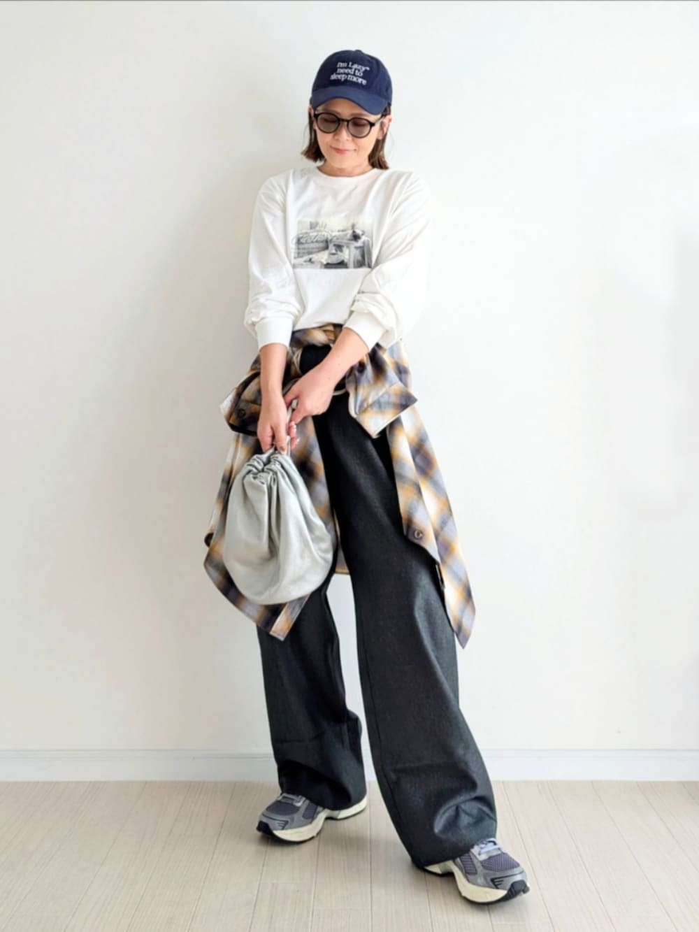 ホワイト系のTシャツ/カットソー、グレー系のスラックス、ホワイト系のシャツ/ブラウスを着用したレディースの秋コーディネートの4枚目の写真
