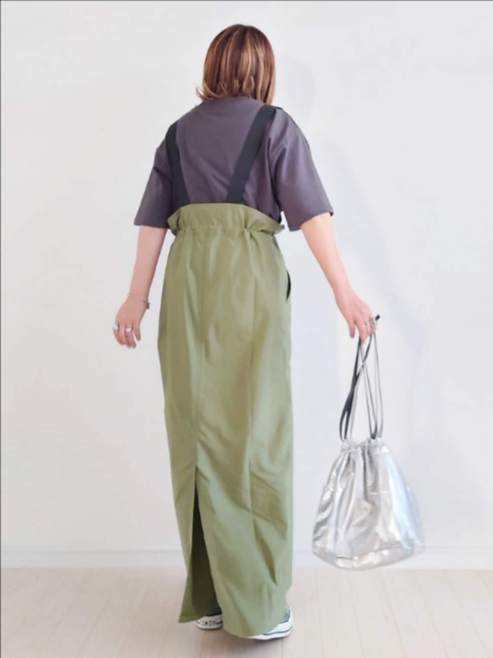 グレー系のTシャツ/カットソー、グリーン系のジャンパースカート、シルバー系のハンドバッグを着用したレディースの夏コーディネートの3枚目の写真