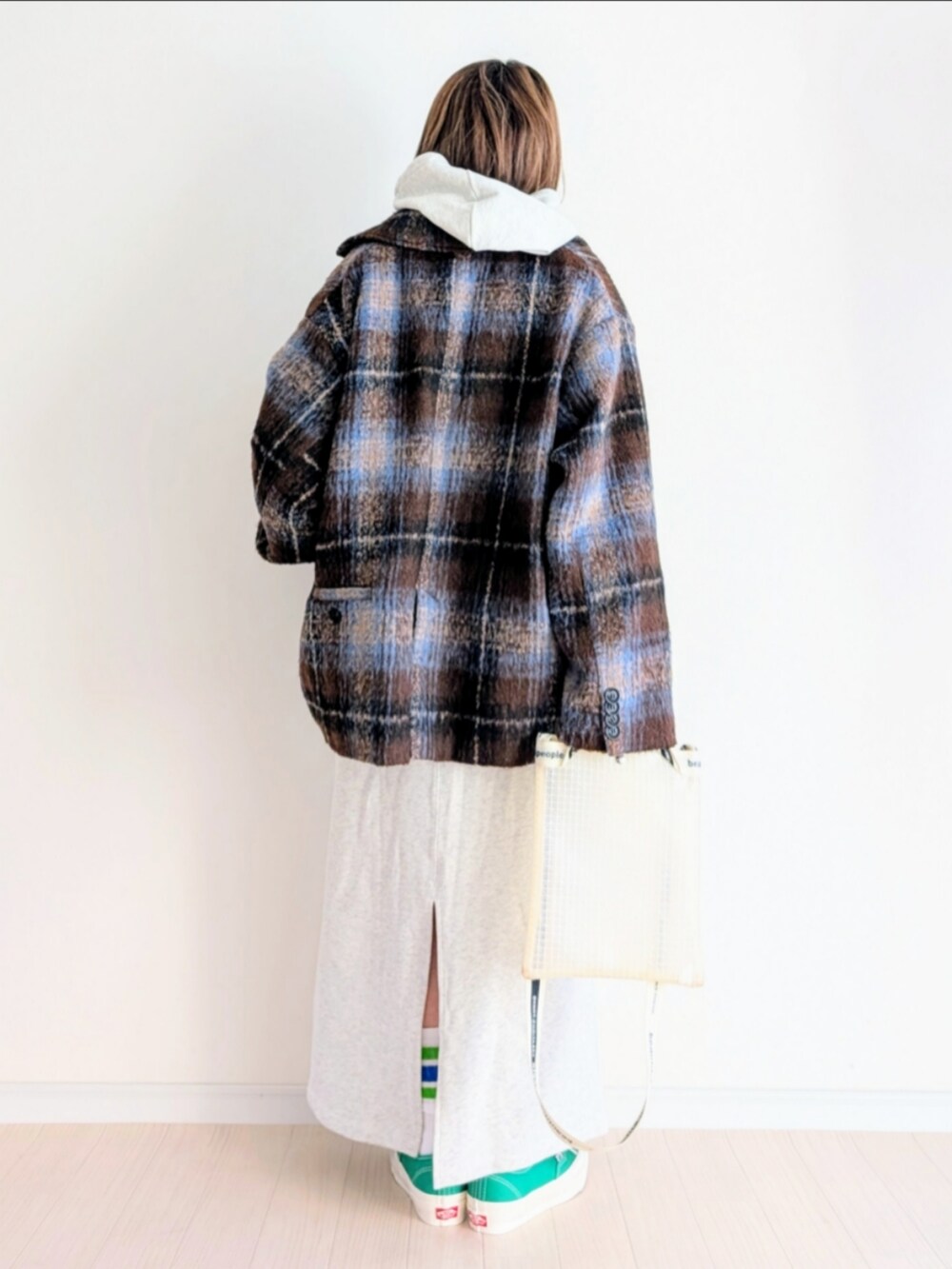 ブラウン系のテーラードジャケット、グレー系のスウェット、グレー系のスカートを着用したレディースの冬コーディネートの3枚目の写真