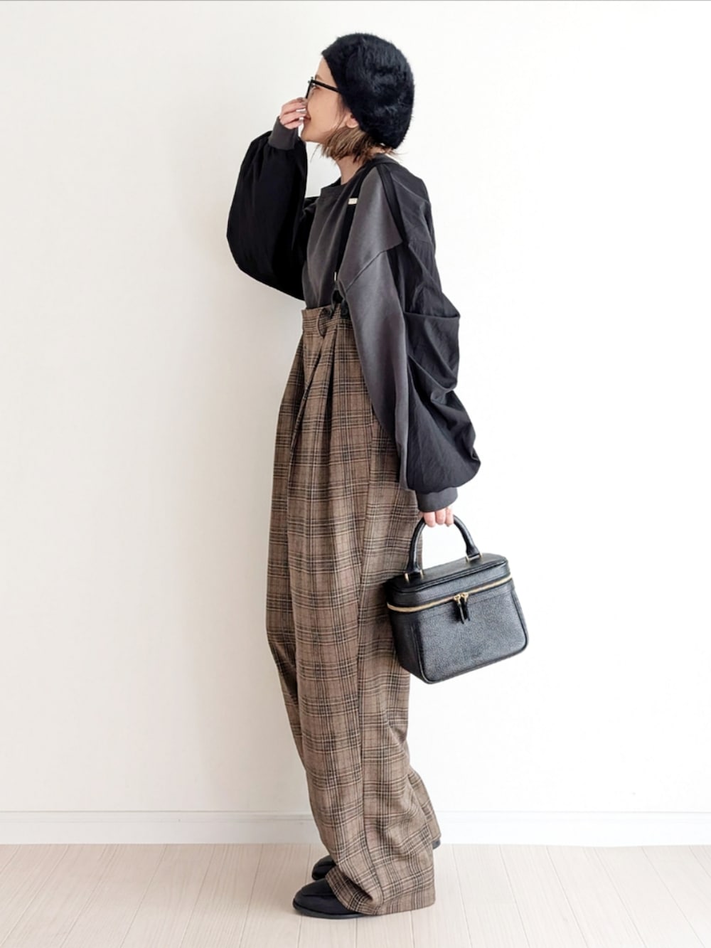 ブラウン系のサロペット/オーバーオール、ブラック系のスウェット、ブラック系のローファーを着用したレディースの秋コーディネートの2枚目の写真