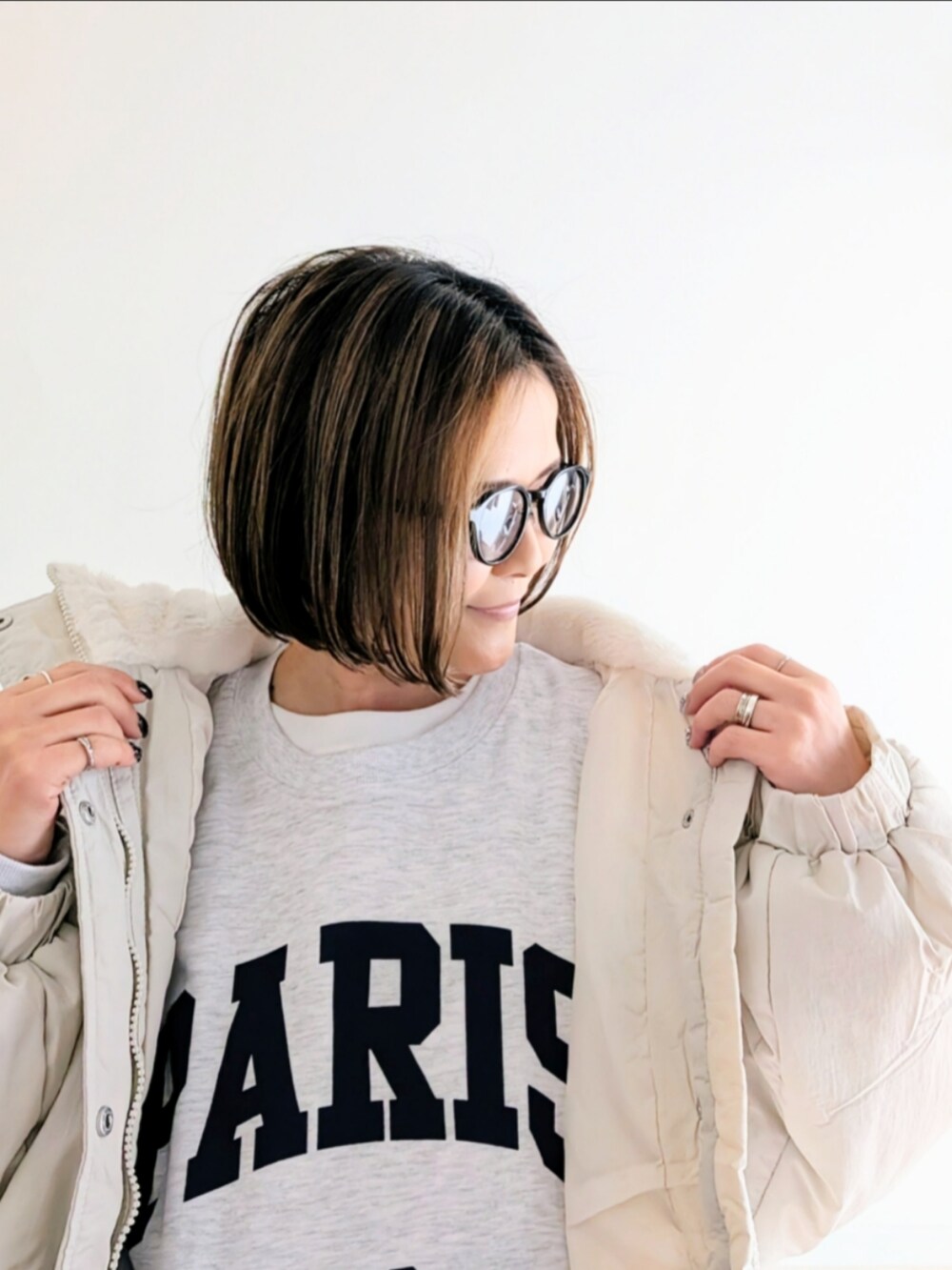 ホワイト系のブルゾン、ホワイト系のスウェット、ブルー系のデニムパンツを着用したレディースの冬コーディネートの5枚目の写真