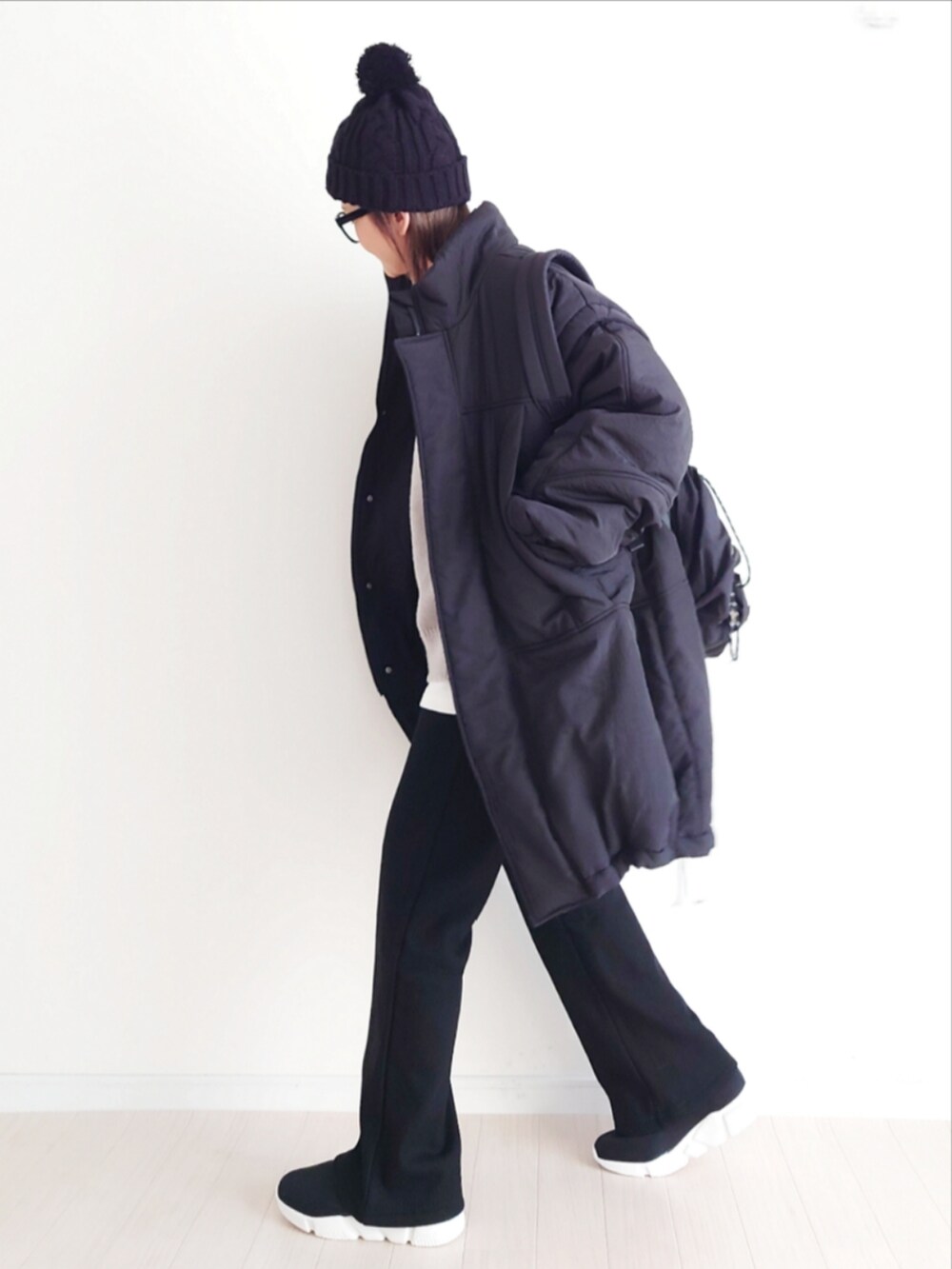 ブラック系のその他アウター、ブラック系のその他パンツ、グレー系のニット/セーターを着用したレディースの冬コーディネートの3枚目の写真