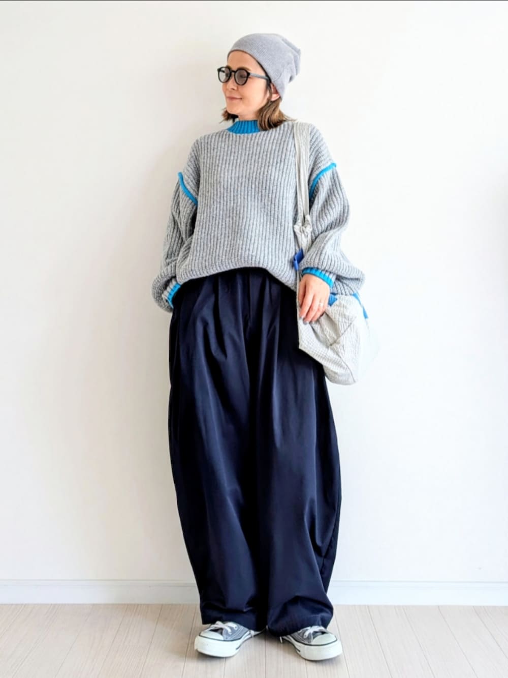 ブルー系のニット/セーター、ブルー系のその他パンツ、グレー系のスニーカーを着用したレディースの秋コーディネートの2枚目の写真