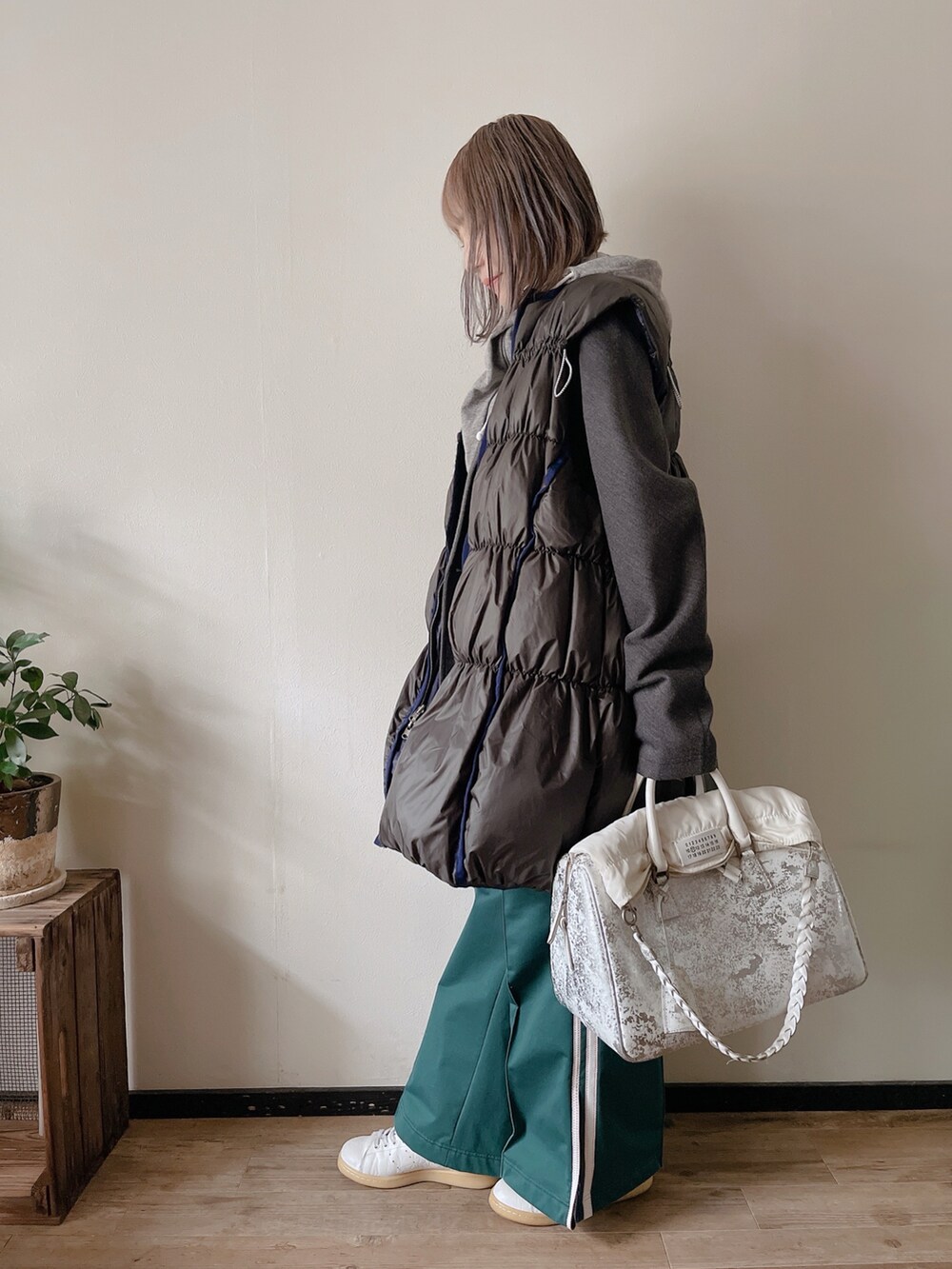 グリーン系のダウンベスト、グレー系のパーカー、グレー系のジャケット/アウターを着用したレディースの冬コーディネートの2枚目の写真