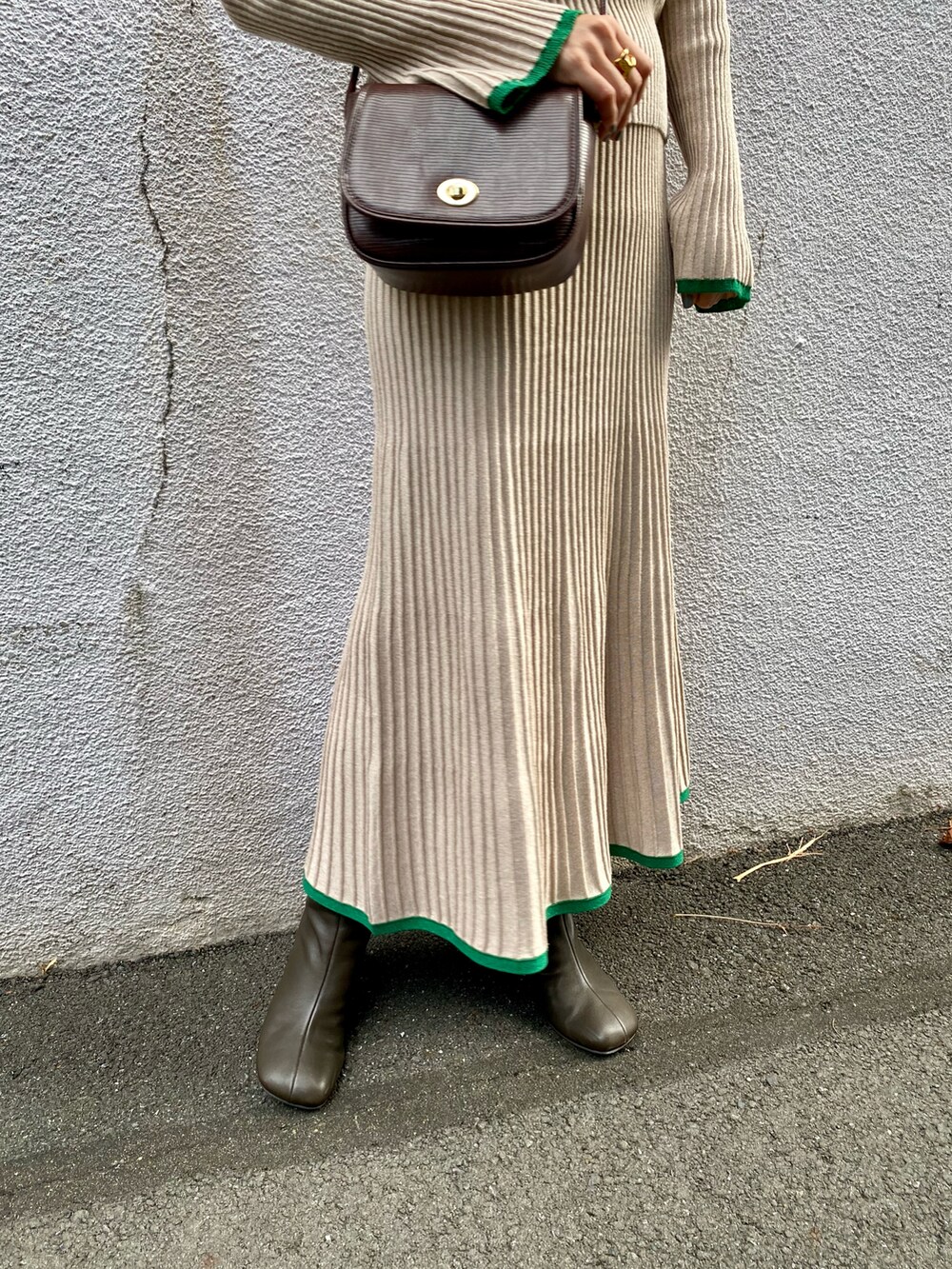 ベージュ系のニット/セーター、ベージュ系のスカート、ブラウン系のショルダーバッグを着用したレディースの冬コーディネートの5枚目の写真