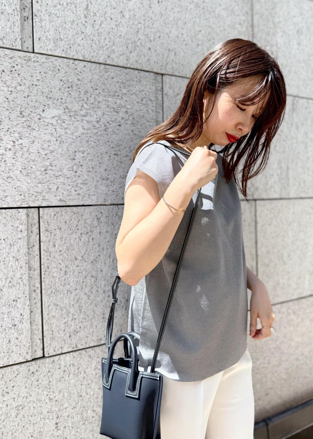 シルバー系のシャツ/ブラウス、ホワイト系のその他パンツ、ブルー系のショルダーバッグを着用したレディースの夏コーディネートの5枚目の写真