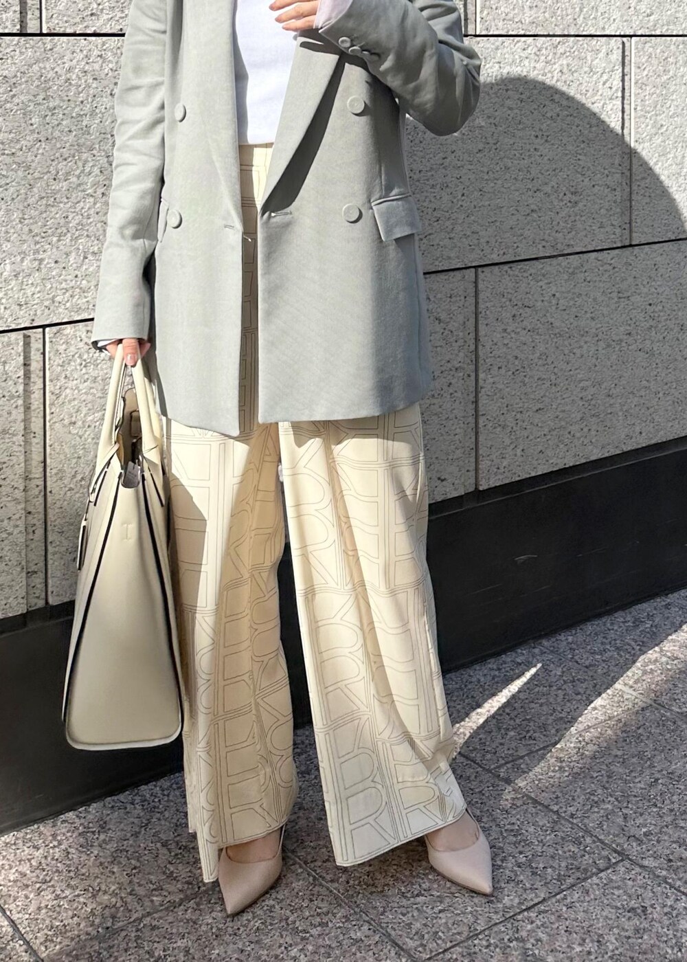 ベージュ系のパンプス、ベージュ系のトートバッグ、ホワイト系のその他パンツを着用したレディースの冬コーディネートの6枚目の写真
